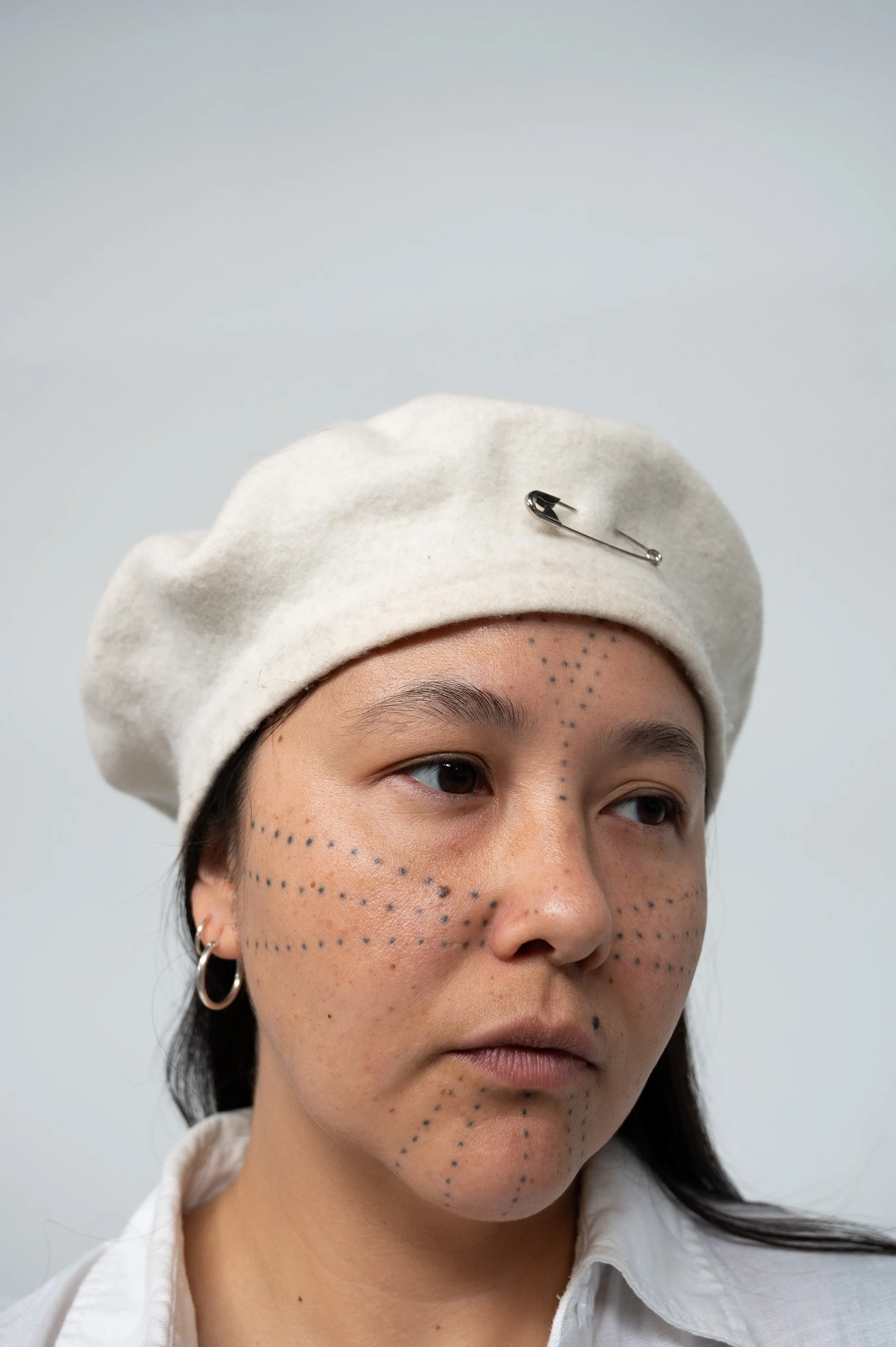 self portrait with béret and safety pin 2024