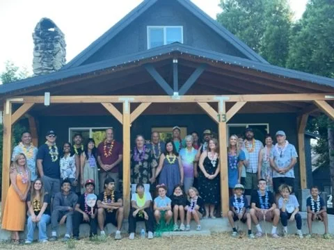 Large family group photo 3 generations on cabin porch