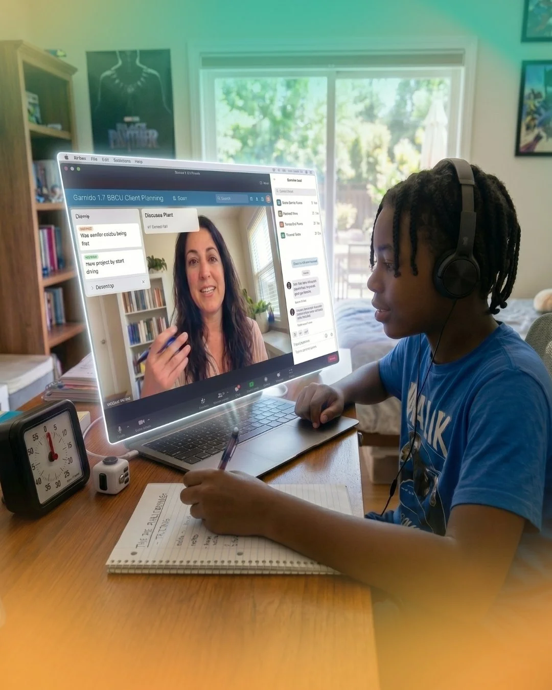 A student participating in an online executive functioning coaching session, taking notes while video chatting with an instructor on a laptop screen