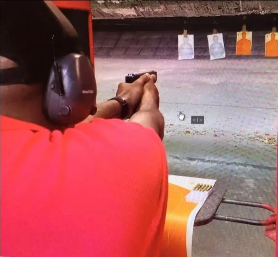 instructor demonstrating proper firing stance aiming downrange towards target