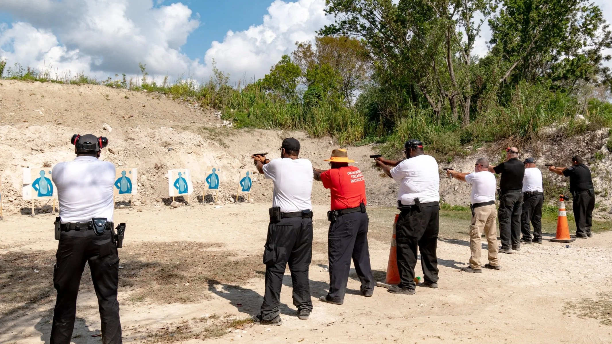 Firearm instructor in group session for outdoor weapons training