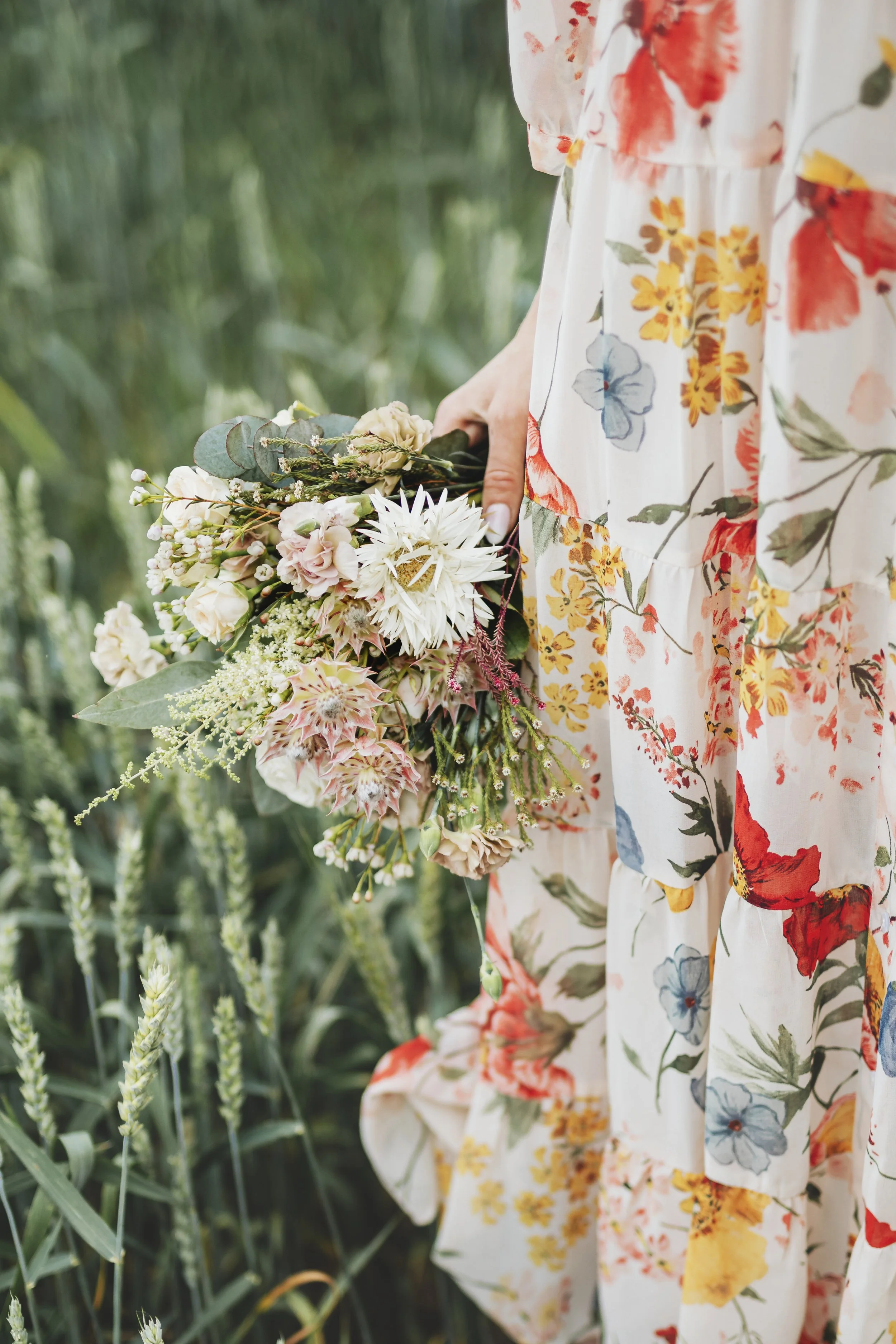 woman-in-a-floral-dress-holding-a-flower-bouquet-2025-02-09-22-53-26-utc.jpg