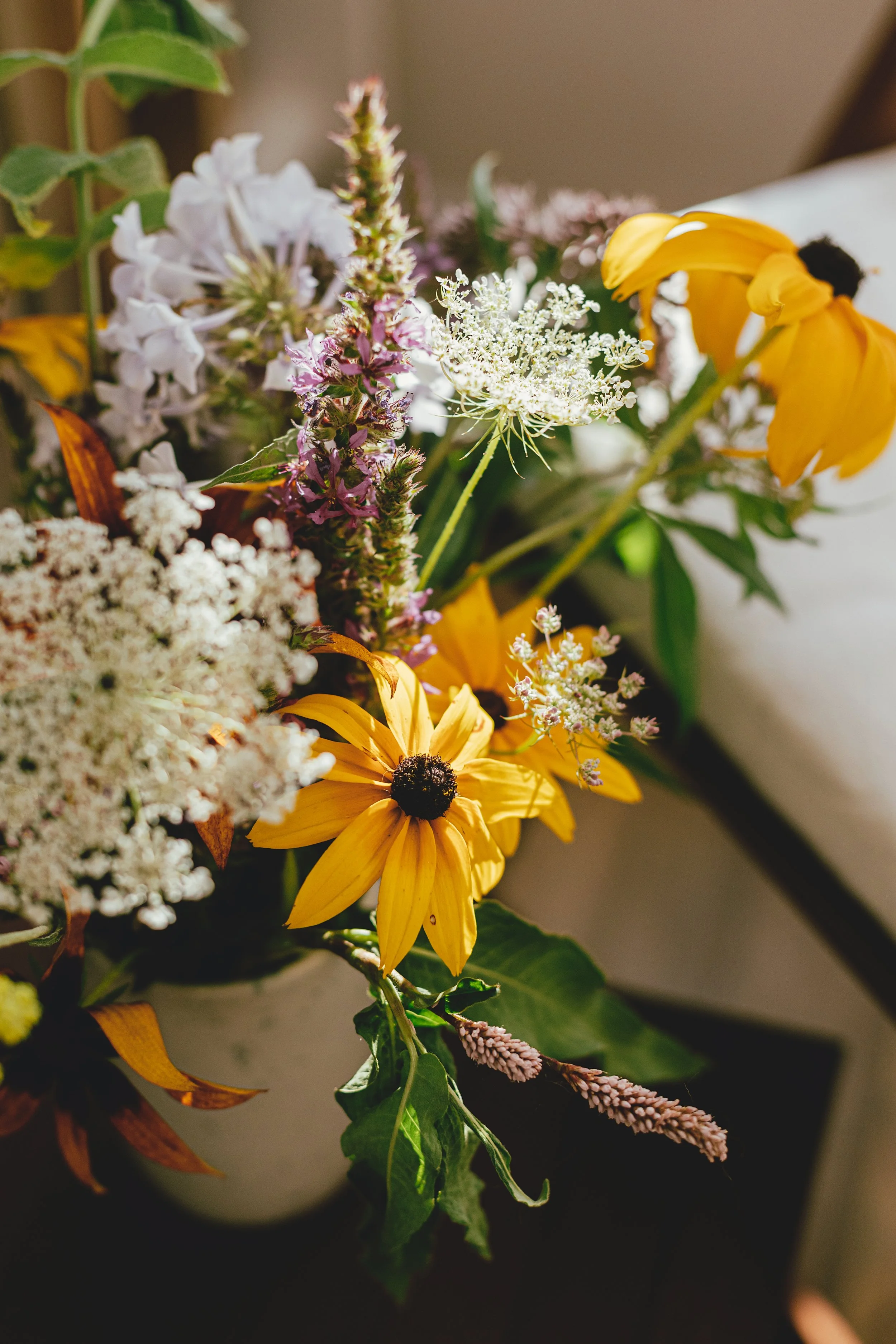 wildflowers-bouquet-on-background-of-wooden-chair-2025-03-15-00-03-07-utc.jpg