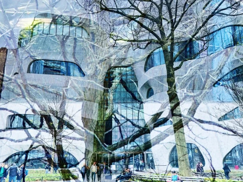 A modern building with a glass exterior by Lisa Meloni Ragusa All Rights Reserved