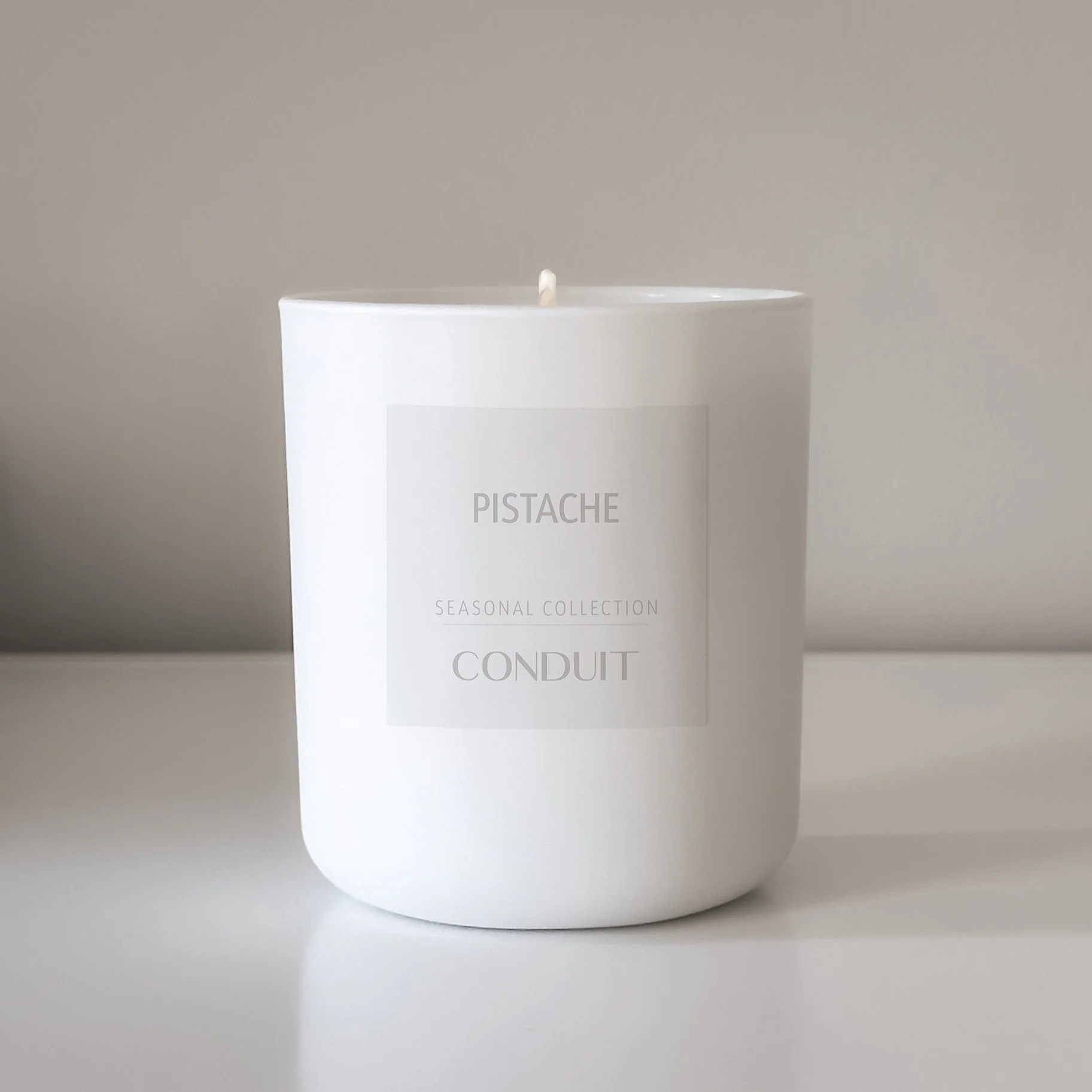 Pistache candle in white glass.