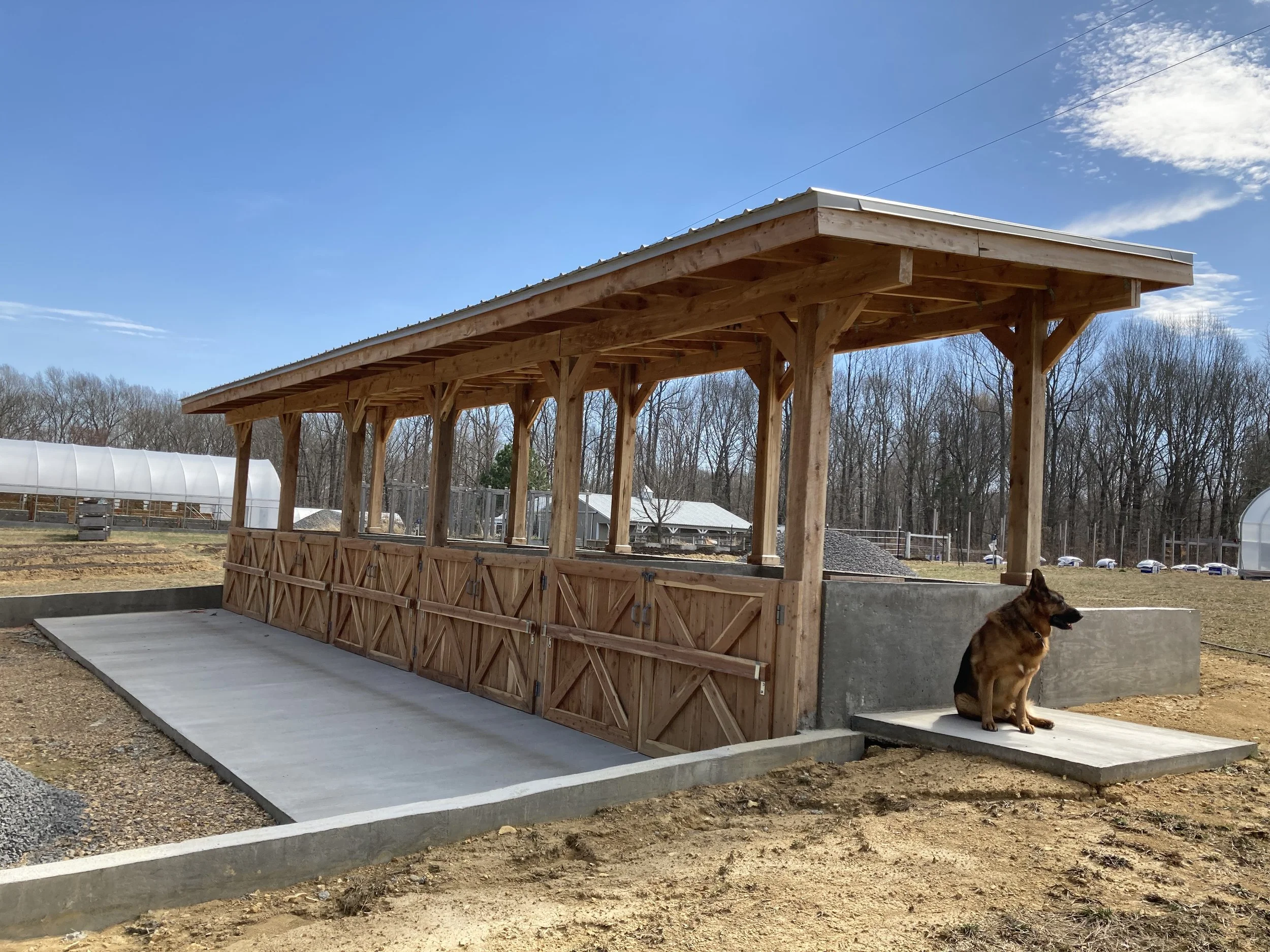 Static aerated compost bins built from concrete and cedar lumber.