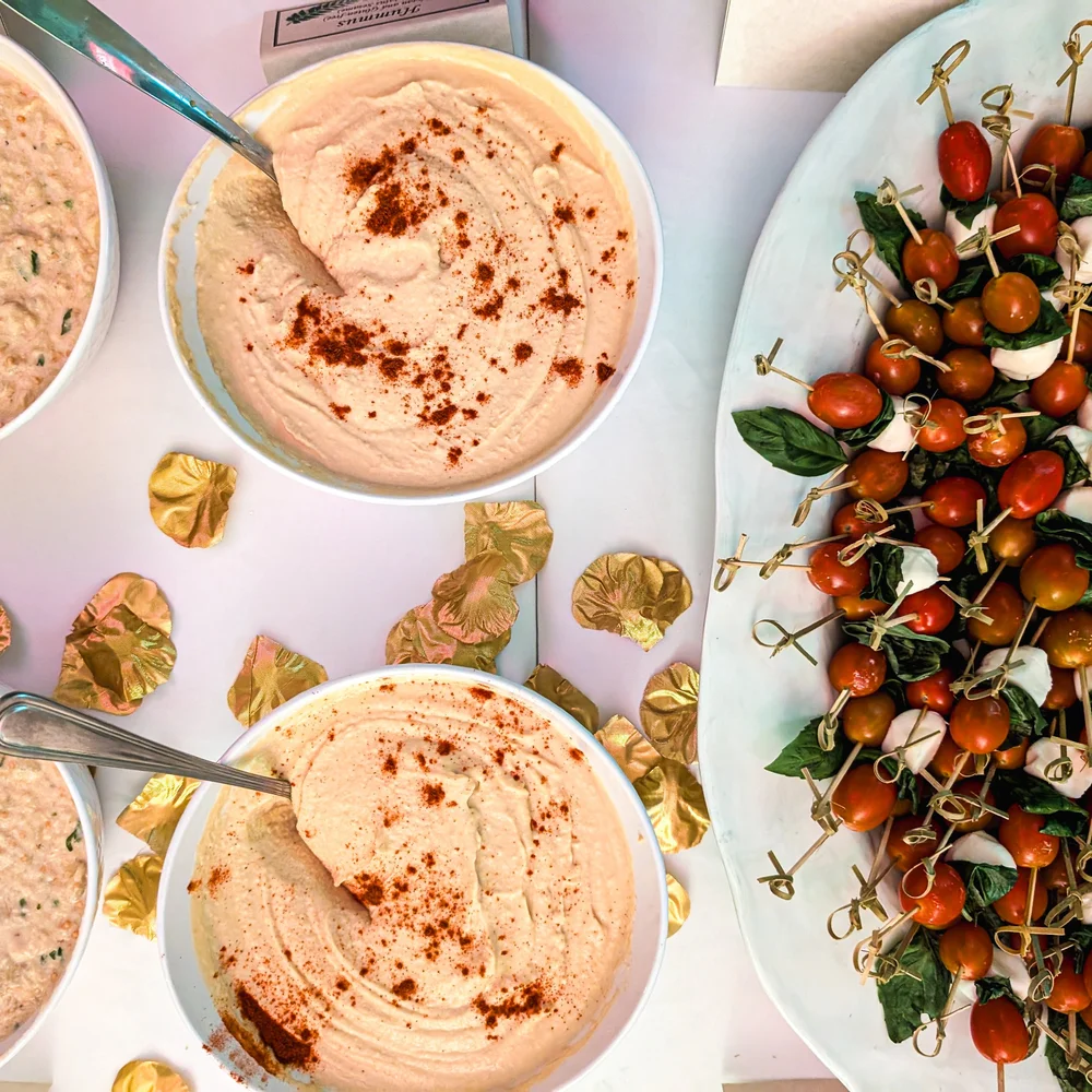 Hummus and caprese skewers laid out for a reception
