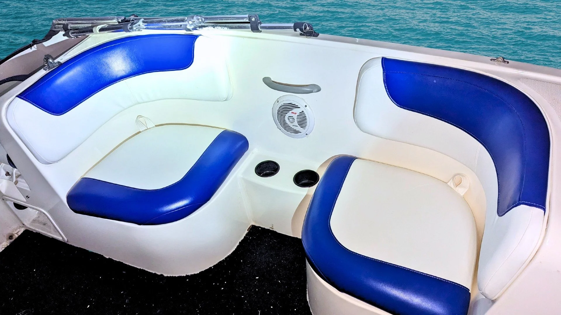 Sport-series cockpit overhaul. This project features a bold 'Deep Sea Blue' accent wrap on classic white marine vinyl. Our custom-tailored skins are designed for a drum-tight fit that eliminates bunching and water pooling, giving this family boat a f