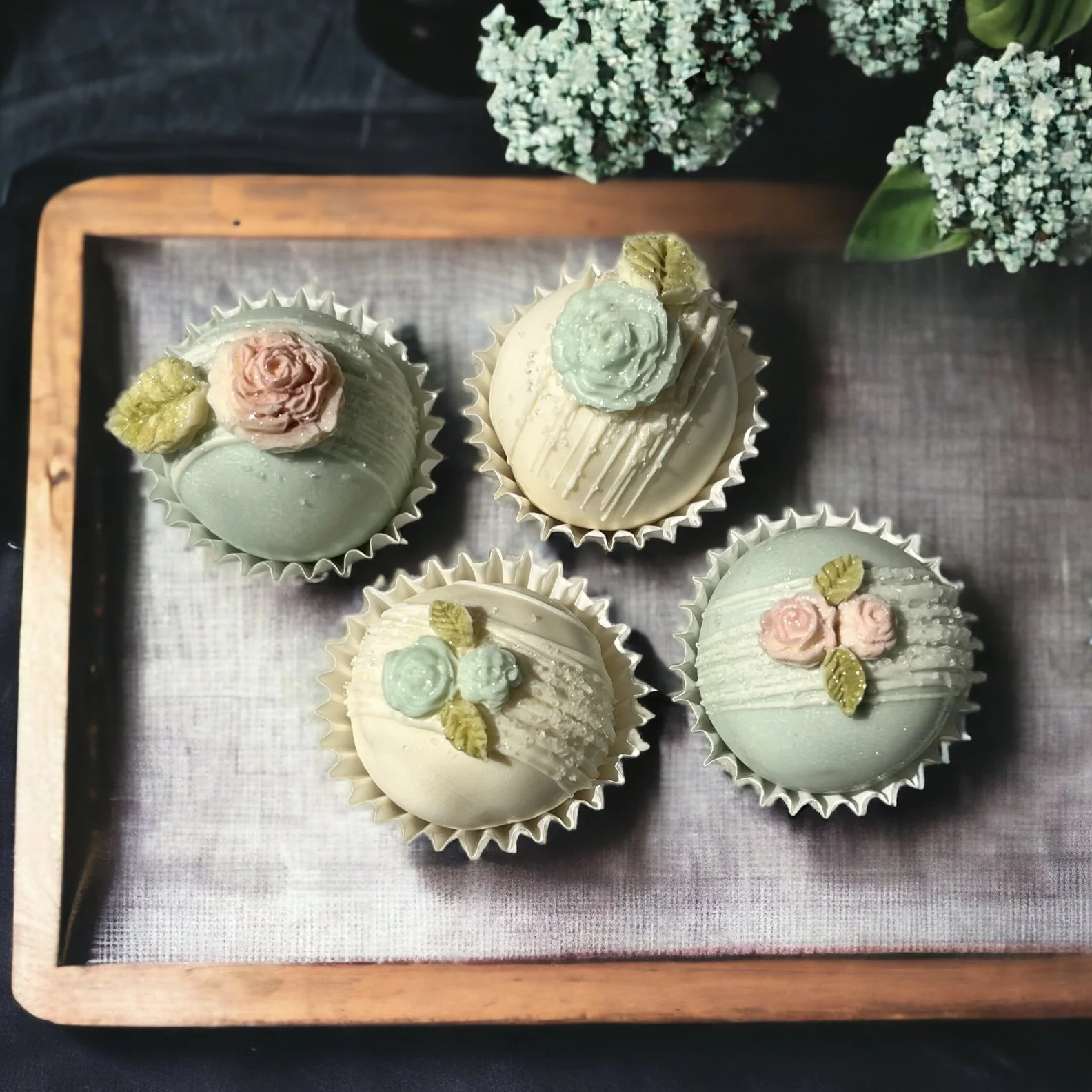 Chocolate covered cake truffles in white and blue with fondant roses 