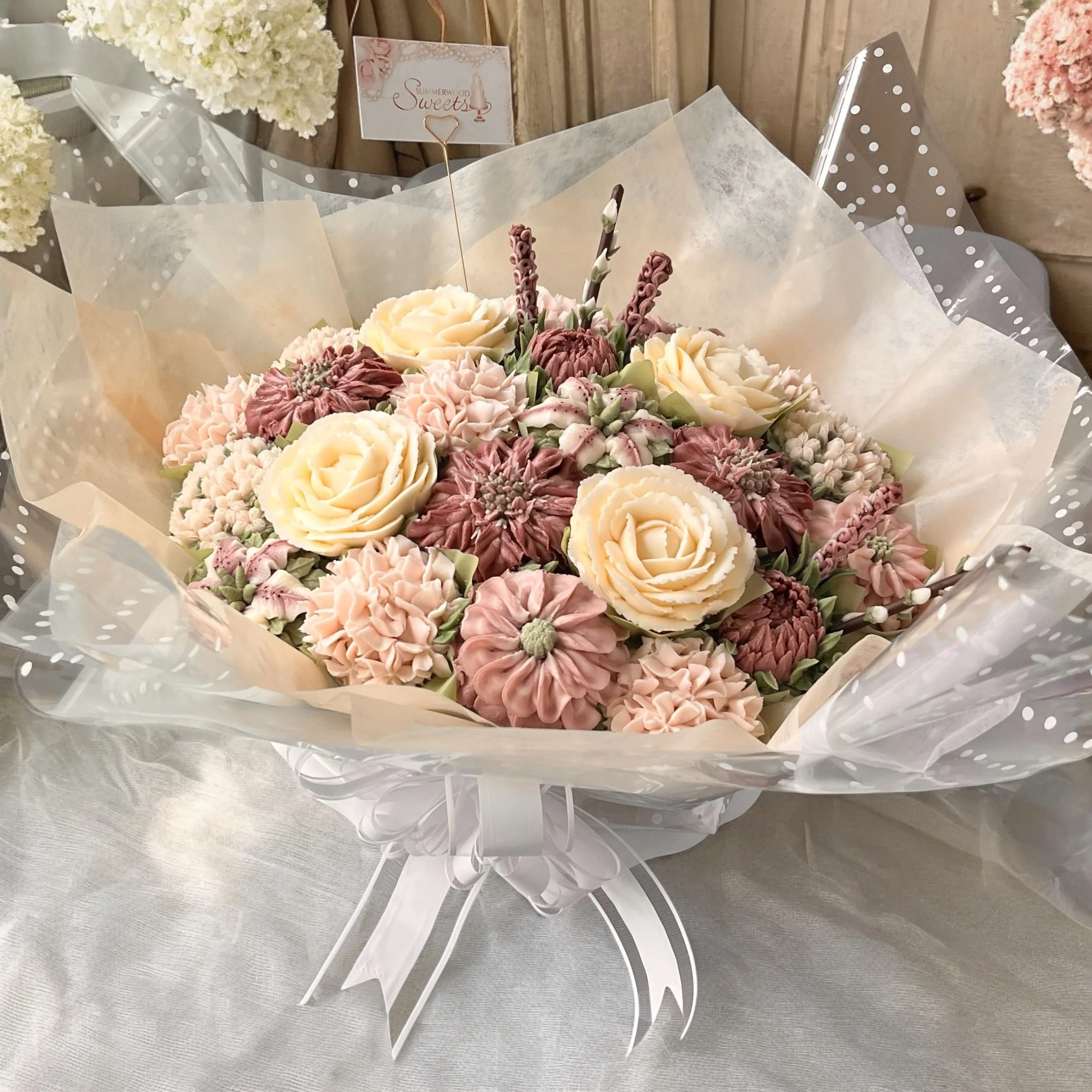 A bouquet of floral cupcakes of various colors