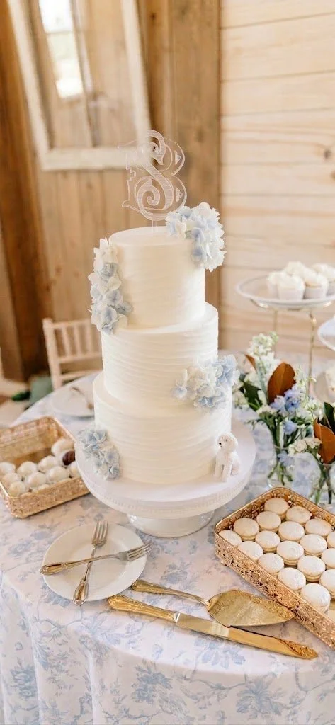 3 tier cake with blue hydrangeas and dog.jpg