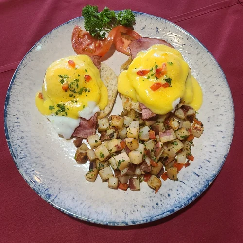 Eggs Benedict with hollandaise and country potatoes
