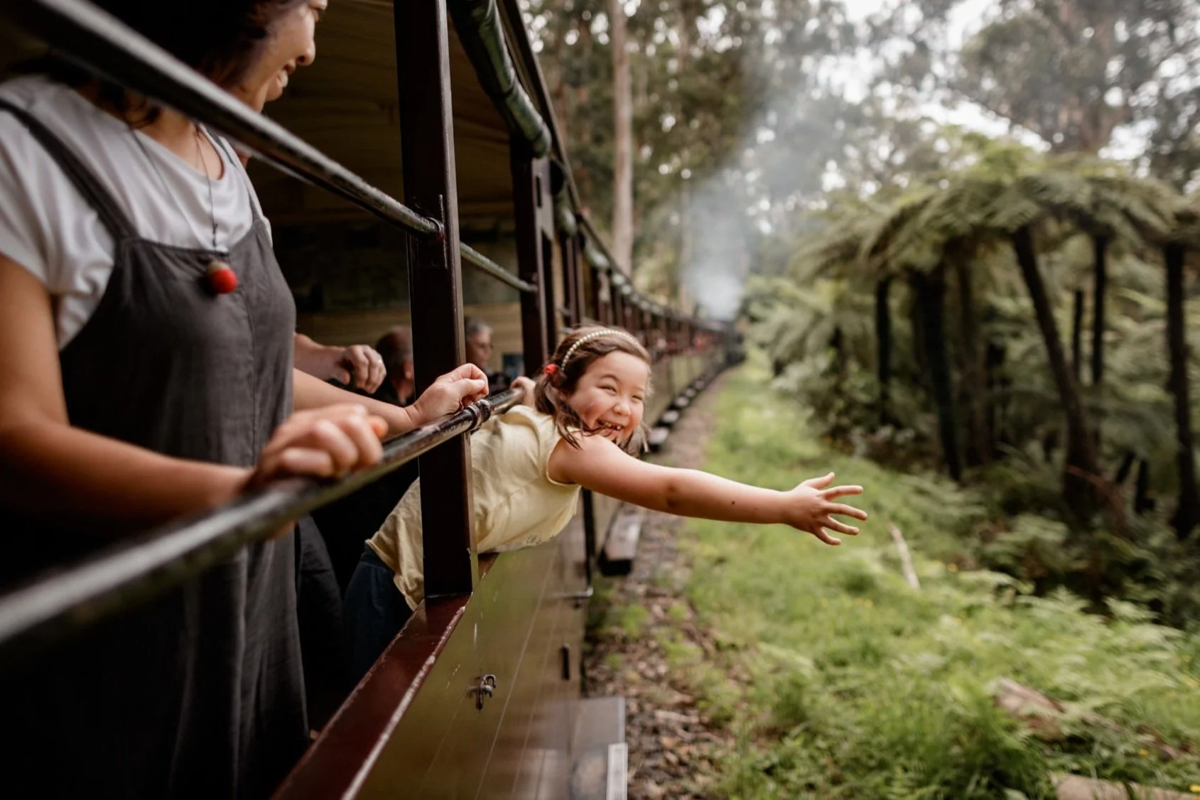 8 Japanese girl smiling and streatching arm out of carriage.jpg