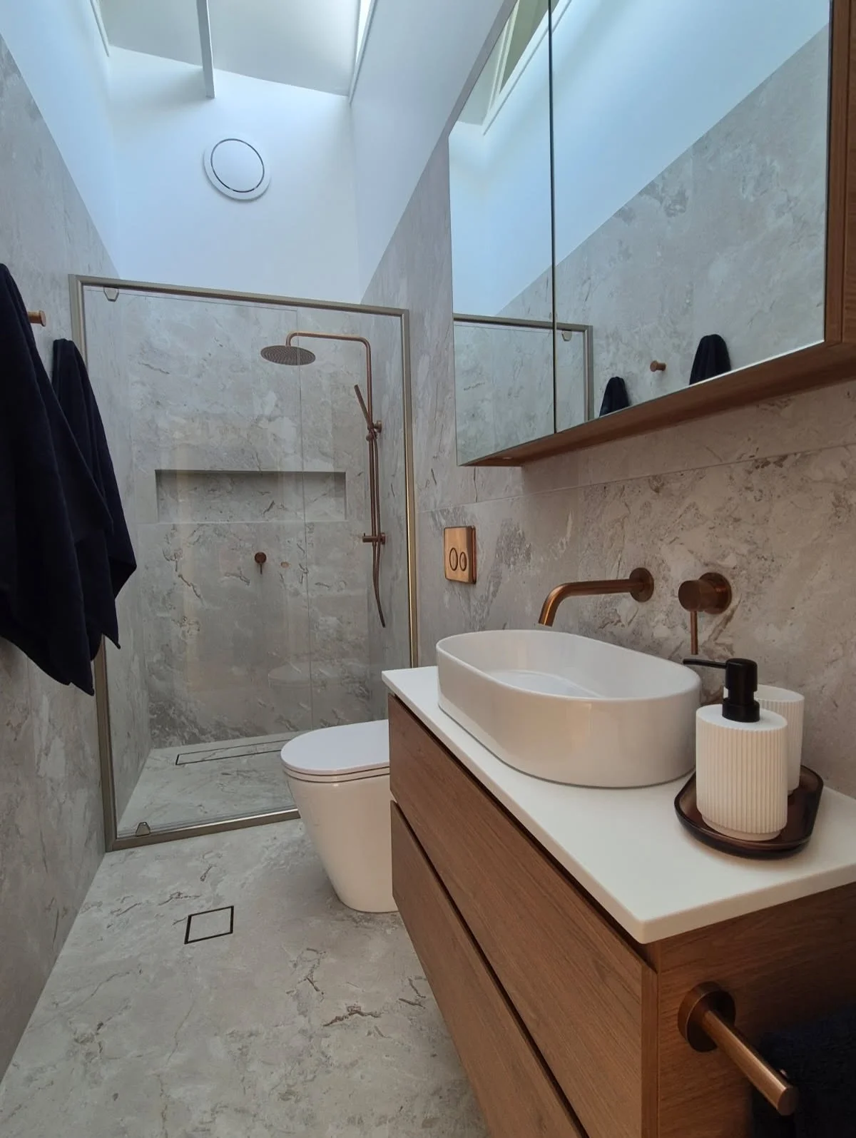 From tired to timeless ✨

This ensuite has been completely transformed with a warm, cohesive colour palette, complemented by brushed copper finishes and oak touches, large format tiles with minimal grout, creating a space that feels calm, modern, and