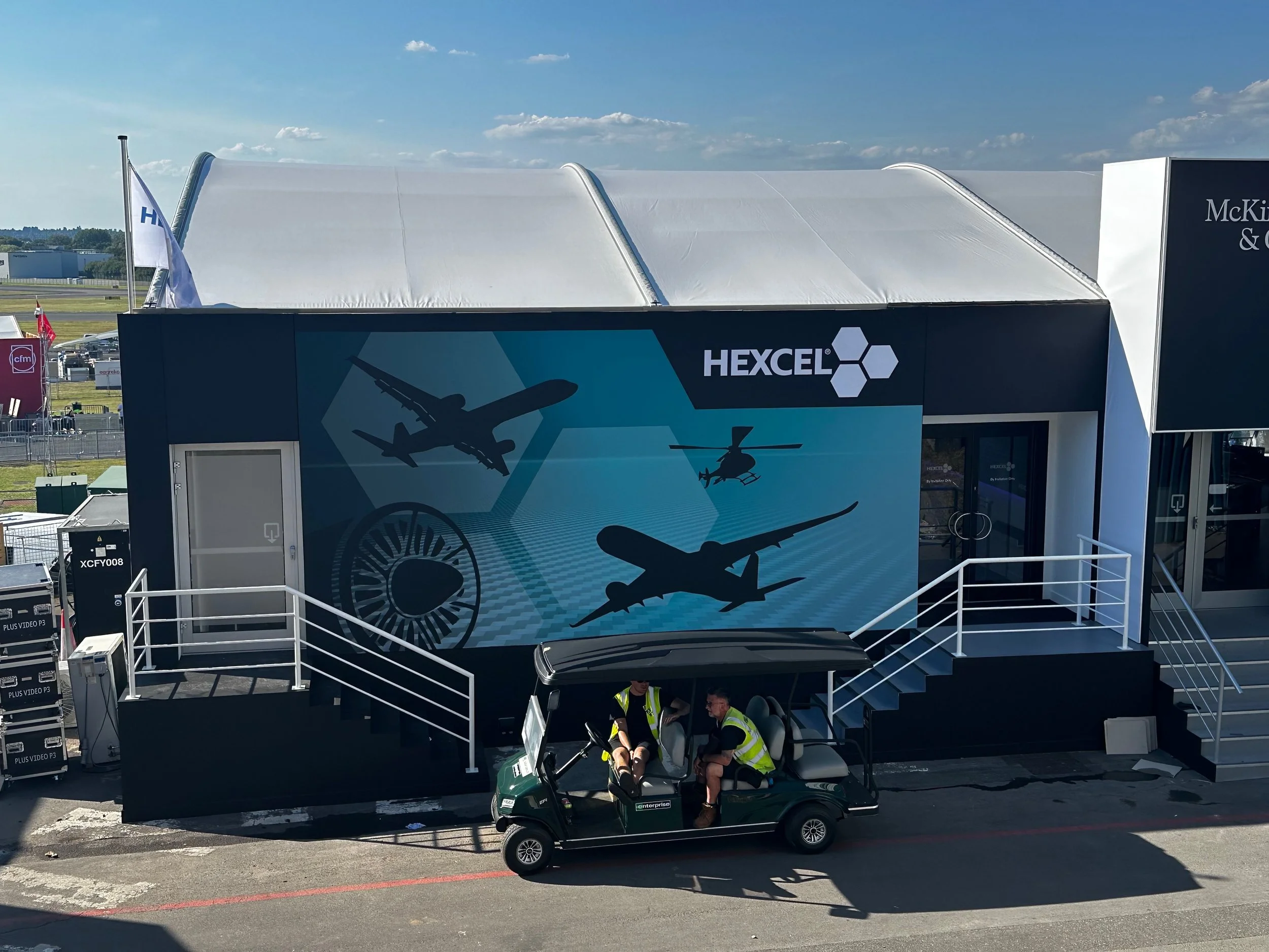 Wide-format blockout fabric was used to wrap the face of this chalet at Farnborough Airshow, delivering a bold, seamless finish that stood out on site.