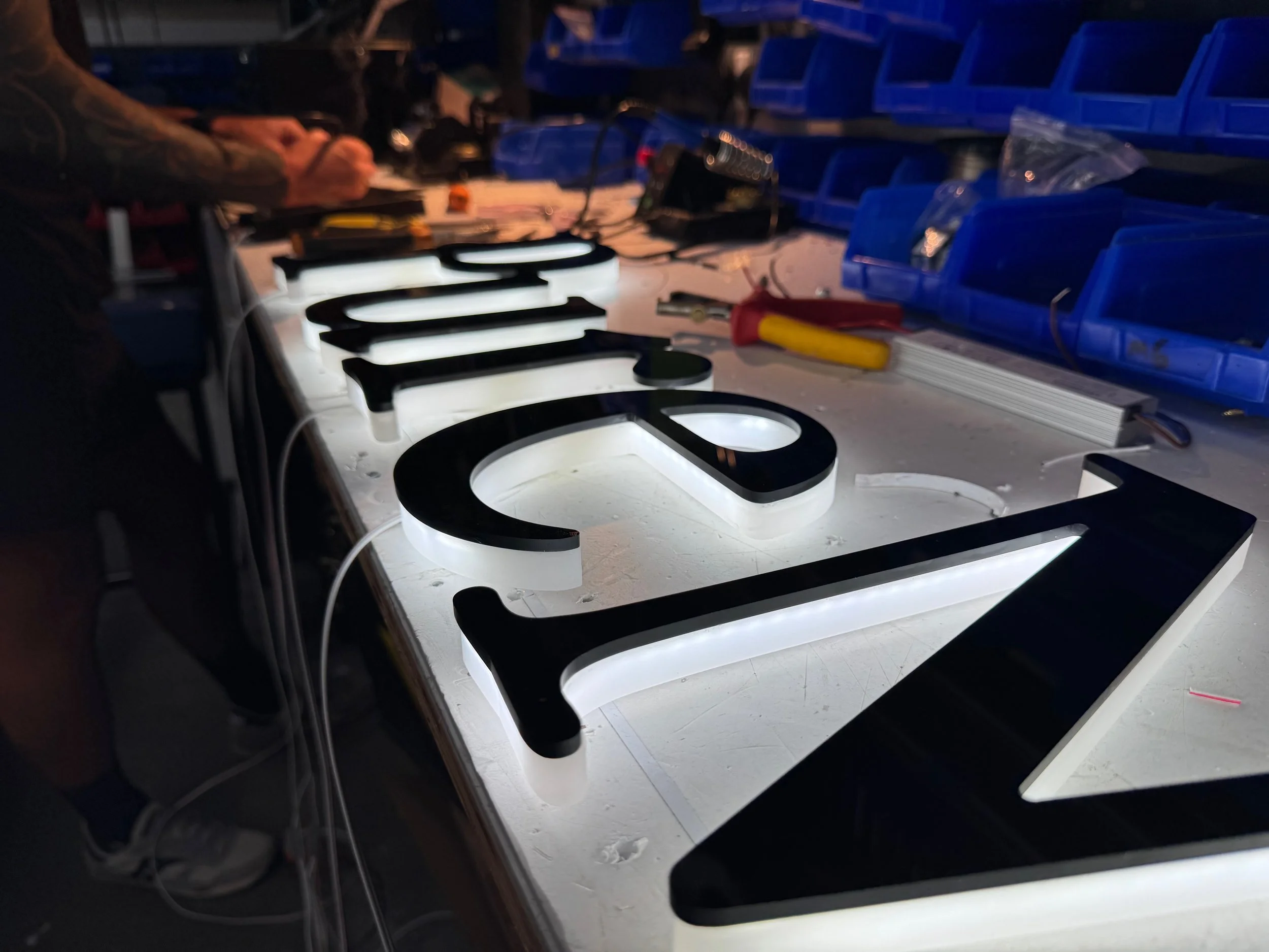 Edge-lit halo letters, faced with black acrylic for a timeless look. Each letter is precision-mounted on press-fit standoffs for a clean, elevated finish.