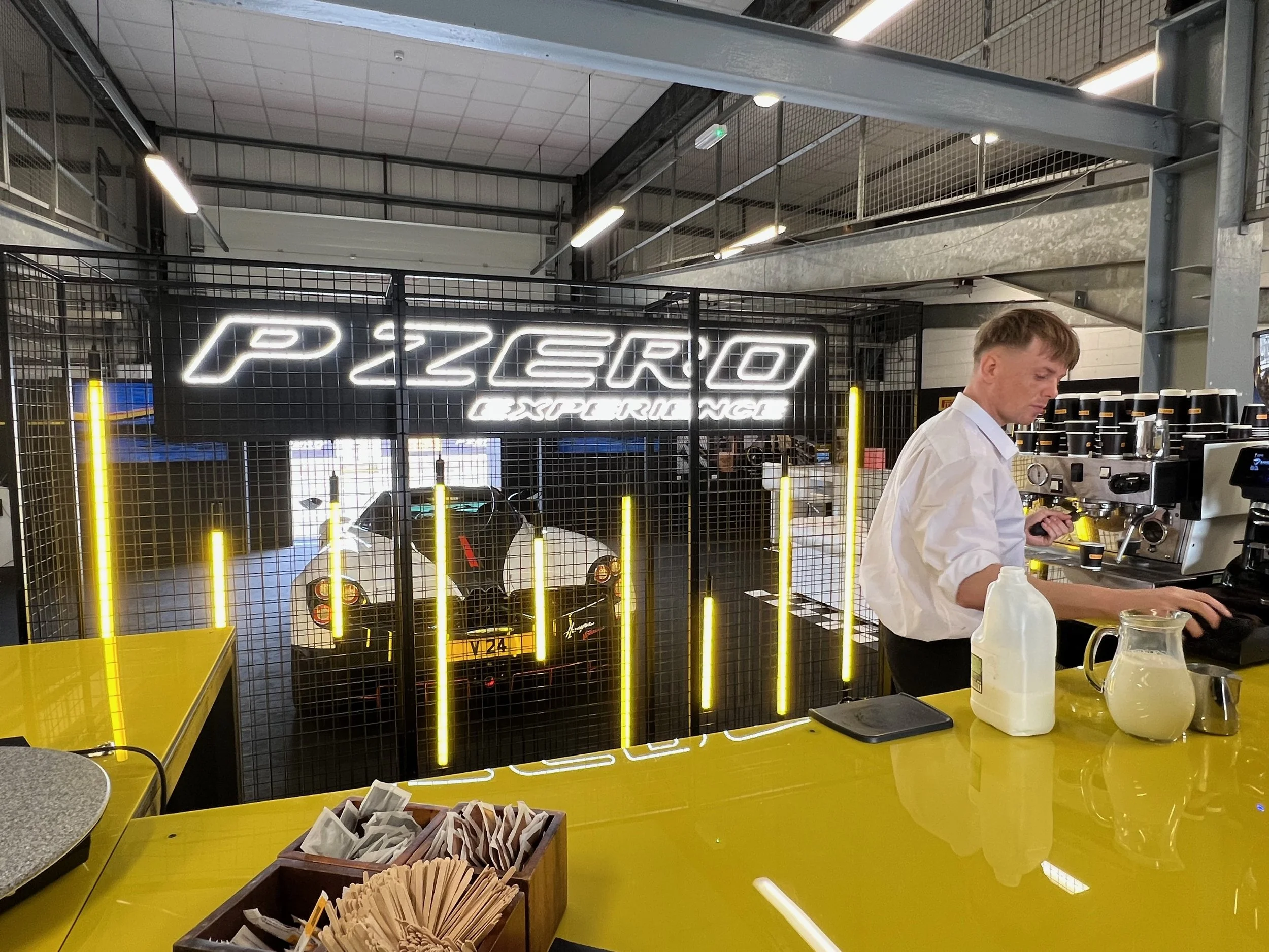 This LED neon sign, suspended within a cage and paired with LED strip lights, created a striking centerpiece with massive brand impact.