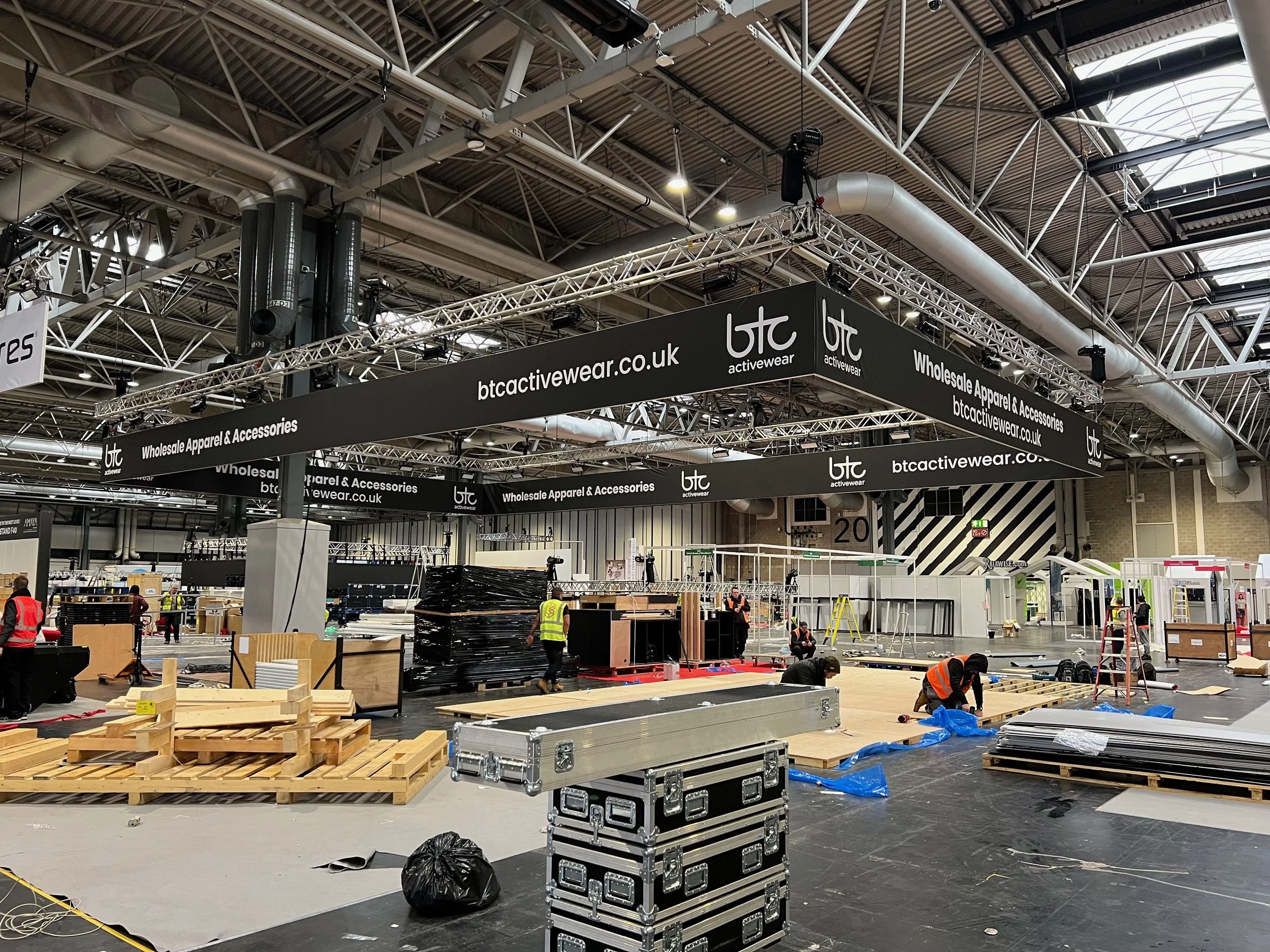 Exhibitor branding elevated with large hanging banner structures. Using our adaptable hire system, we create bespoke solutions to meet every need.