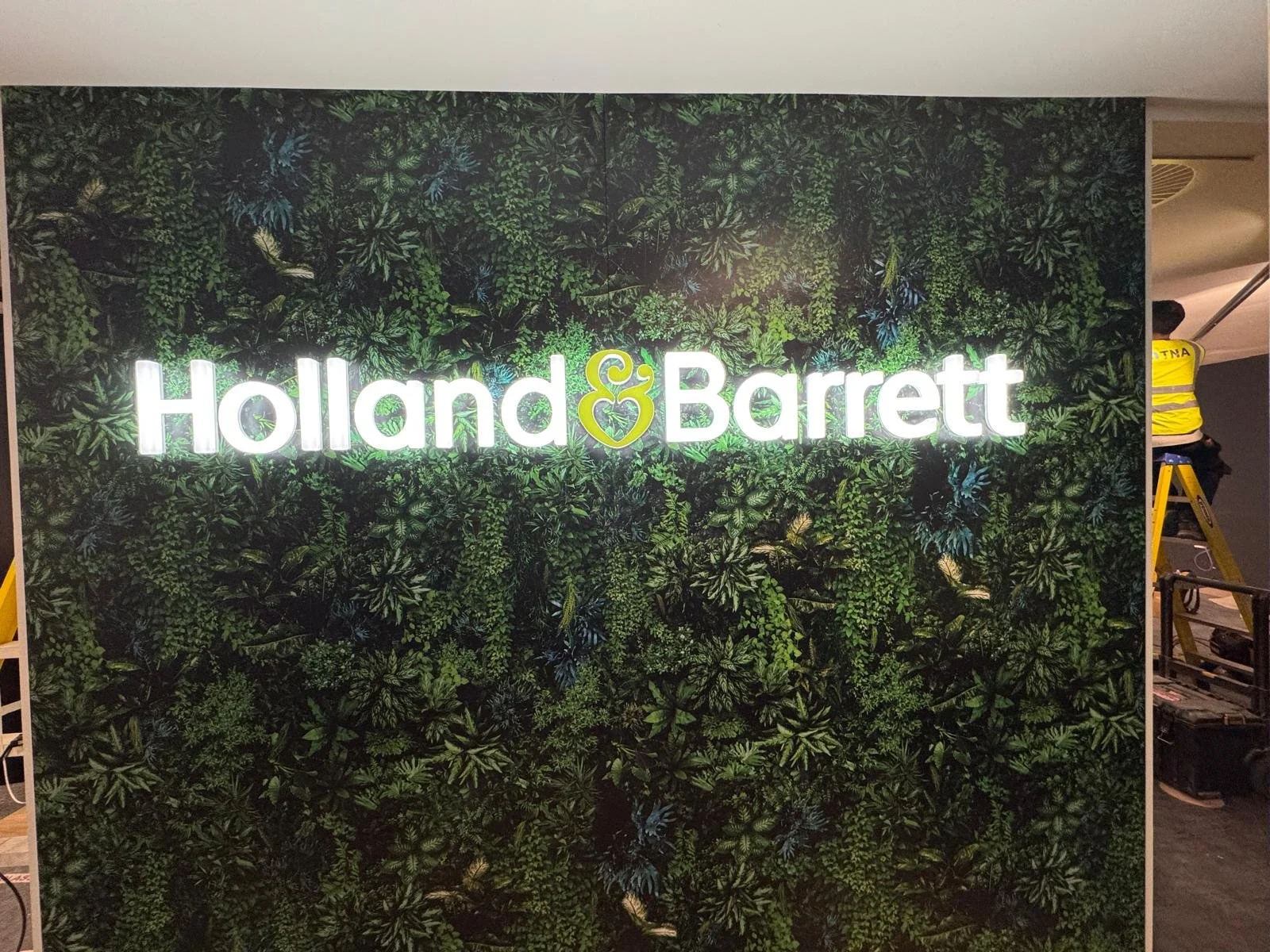 Striking wall covering and illuminated sign for Holland & Barrett