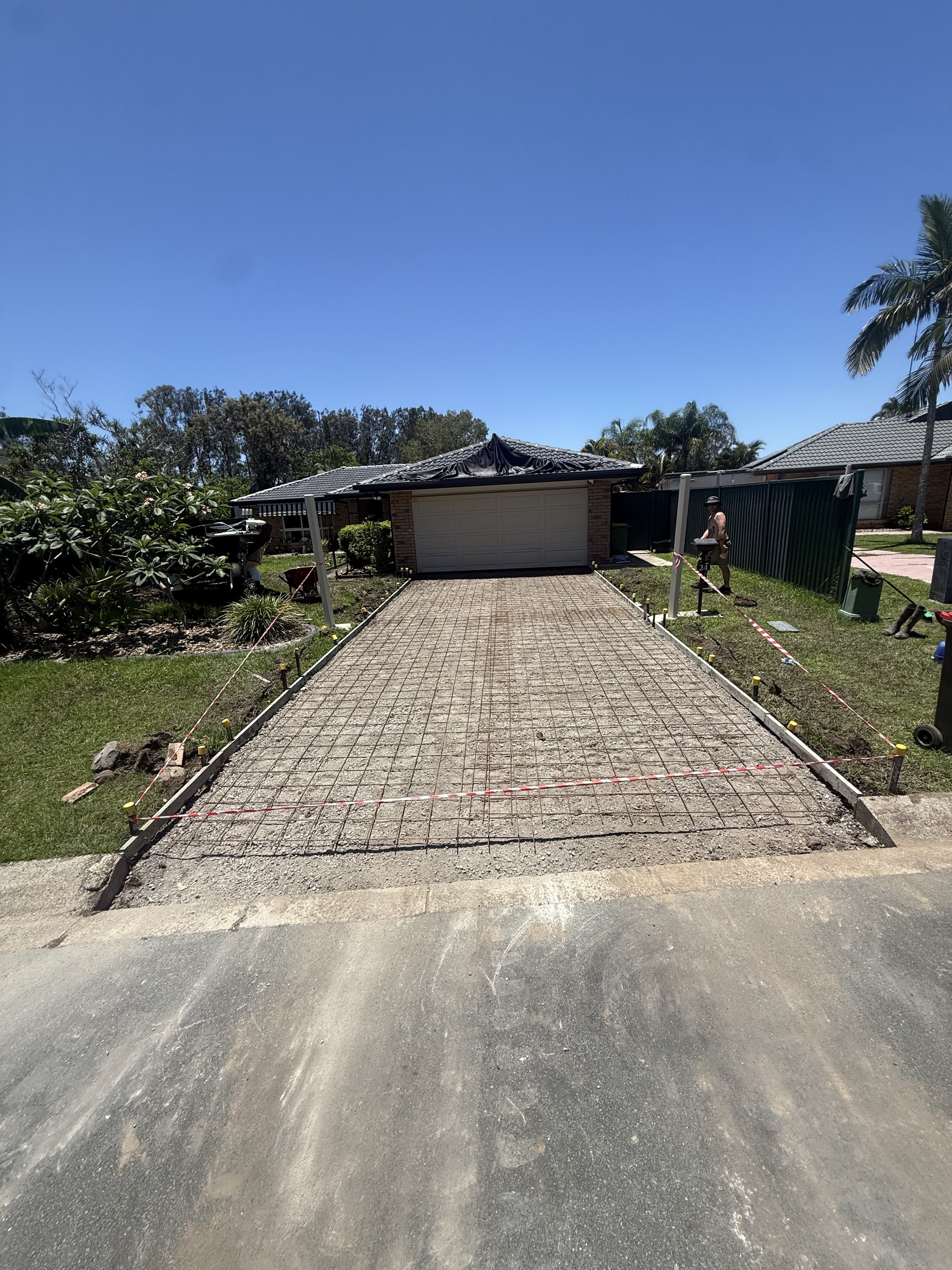 A newly poured concrete driveway under construction in Gold Coast residential property