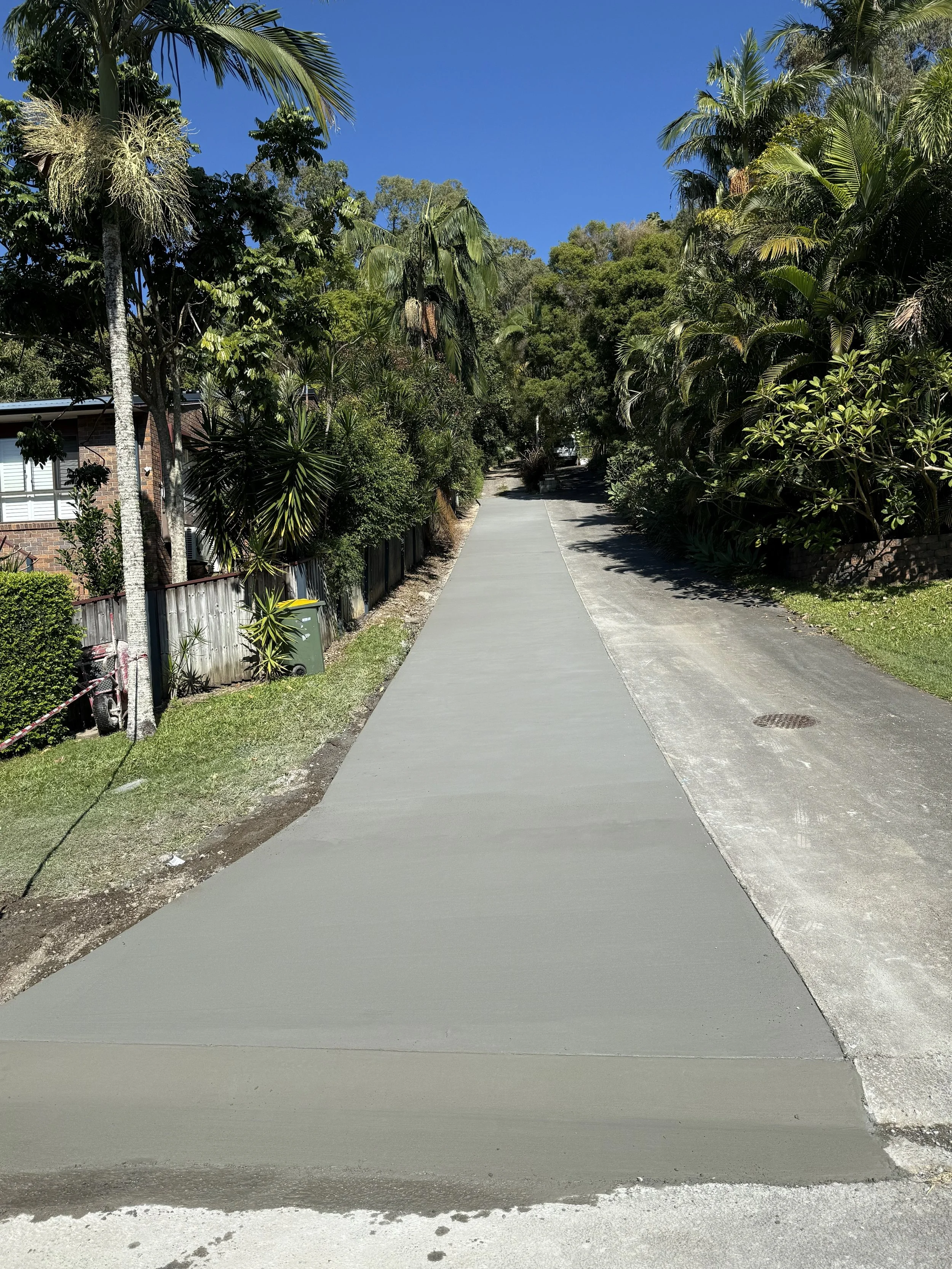 Newly poured concrete driveway with clean broom finish