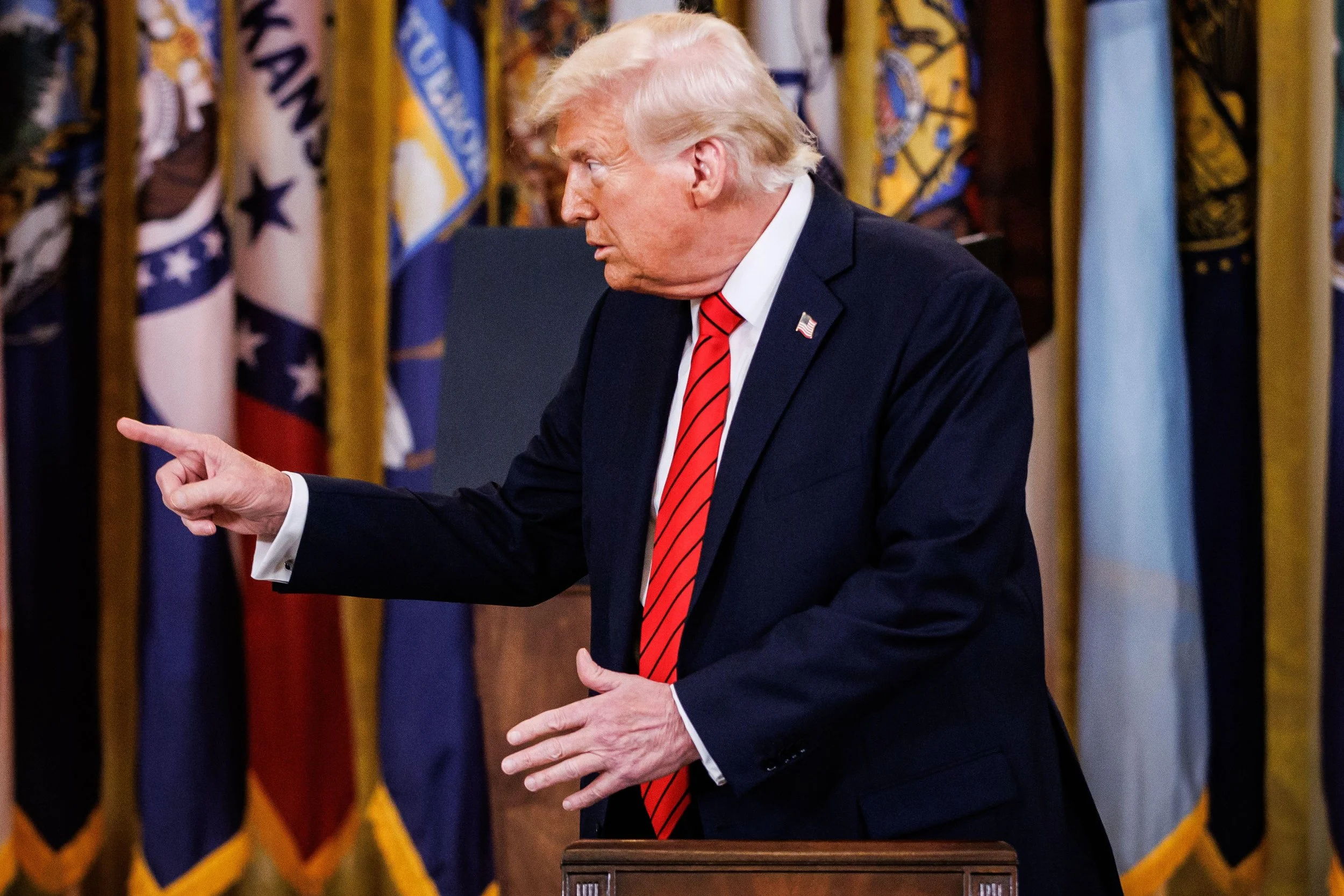 US President Donald Trump gesturing at reporters.