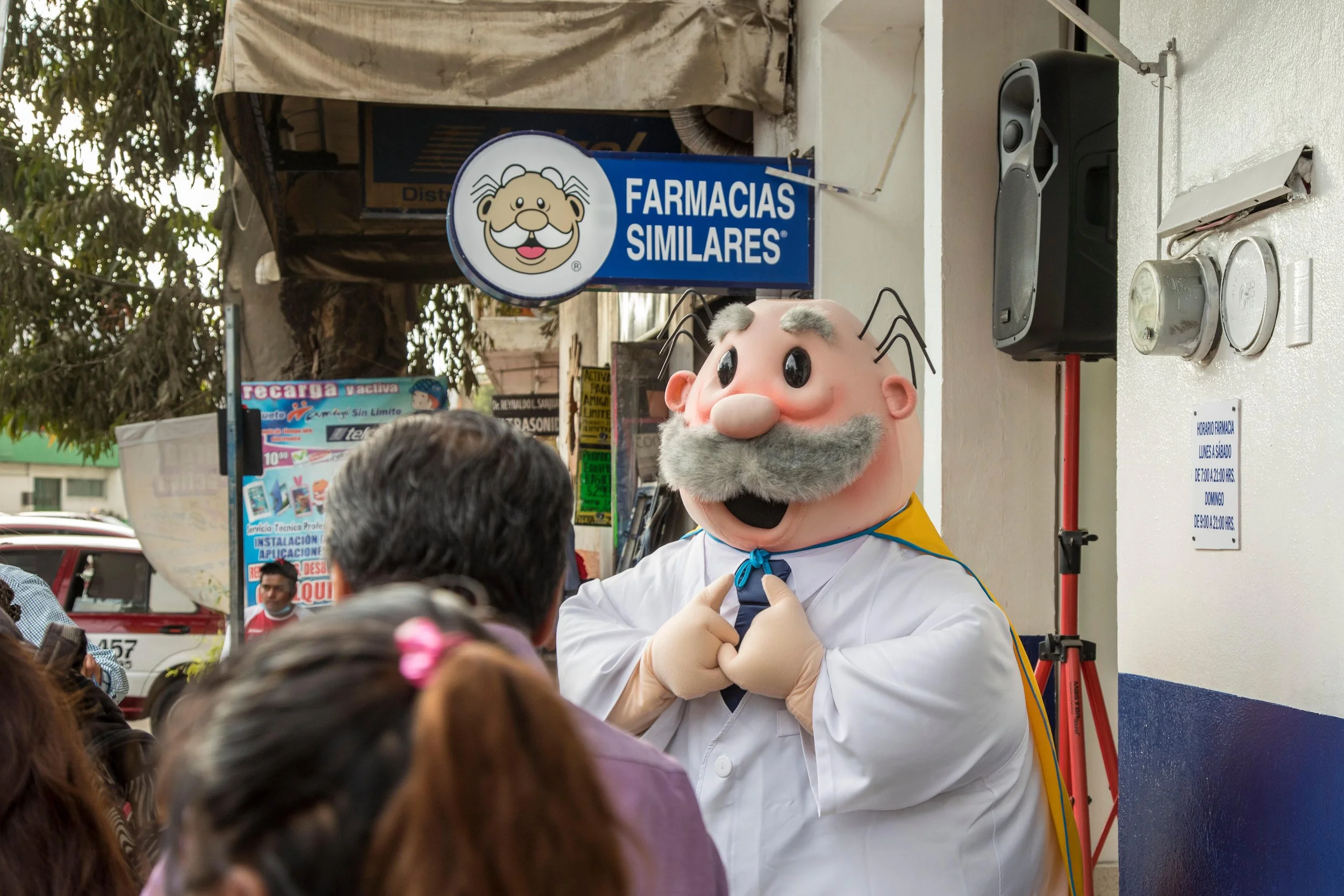 Mexicans lining up outside Farmacias Similares and a Dr Simi figure