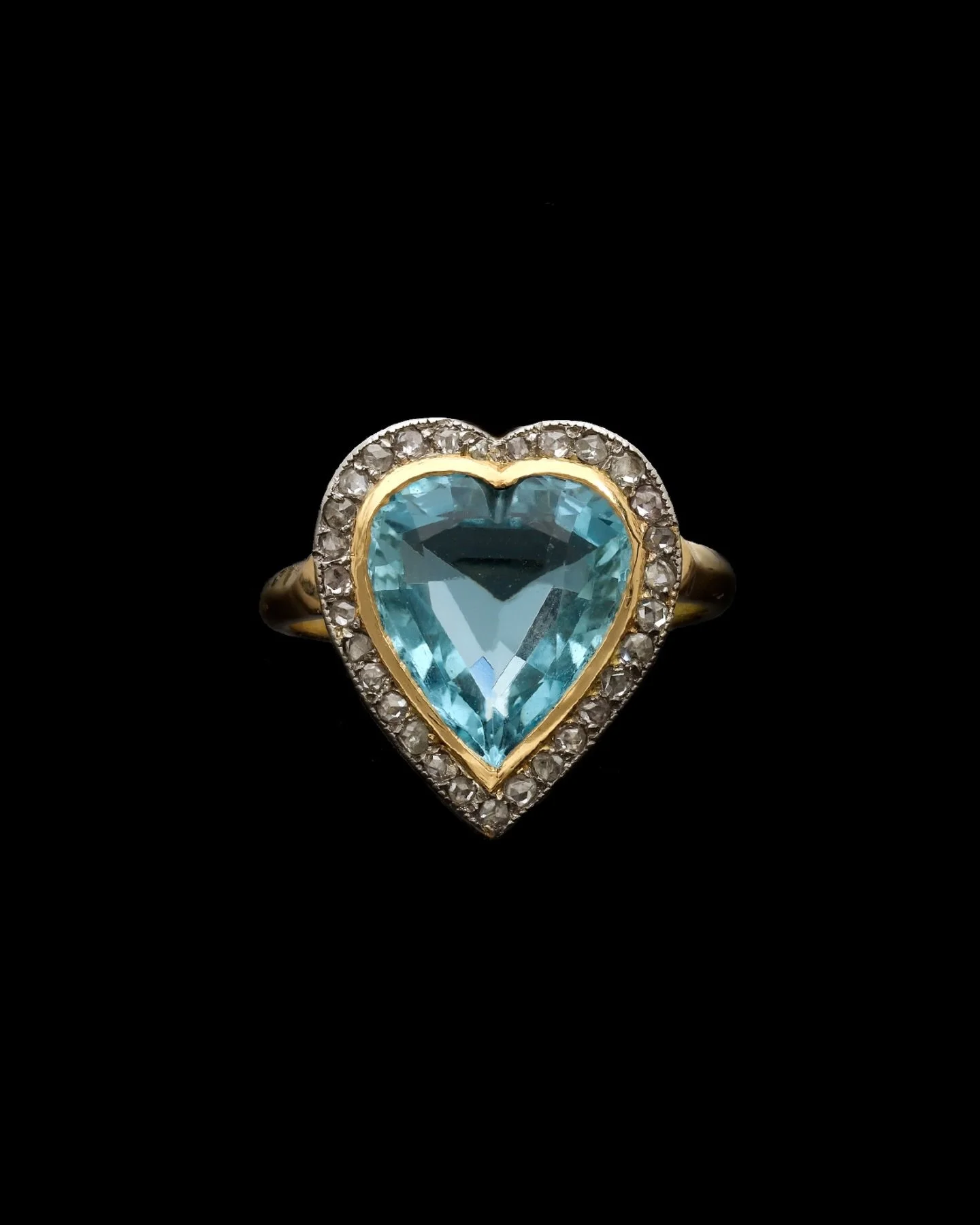EARLY 20TH CENTURY AQUAMARINE &amp; DIAMOND HEART RING

Set with a heart shaped aquamarine weighing approximately 4.00 carats surrounded by rose cut diamonds. Diamonds are bright &amp; lively. Mounted in Platinum on 18kt yellow gold. Circa 1910. Pric