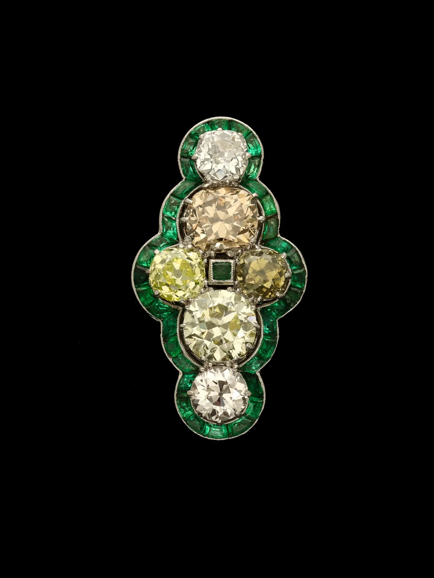 EARLY 20TH CENTURY FANCY DIAMOND &amp; EMERALD CLUSTER RING

Set with old european cut diamonds surrounded by calibr&eacute; cut emeralds. Faint pink diamond weight 0.77 carats. Fancy Intense Greenish Yellow diamond weight 0.92 carats. Estimated ligh