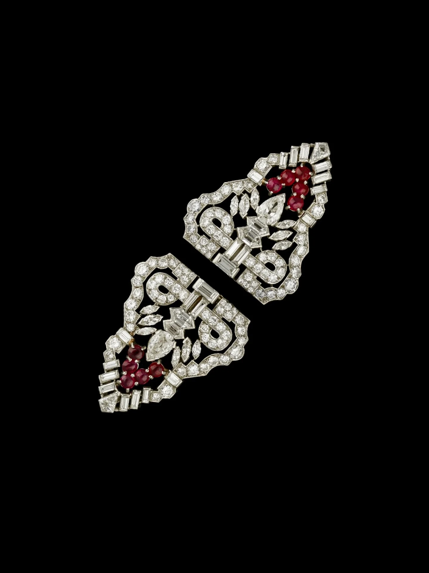 ART DECO DIAMOND &amp; RUBY DOUBLE CLIP BROOCH

Set with old cut diamonds and cabochon cut rubies. Estimated total diamond weight 11.50 carats. Estimated ruby weight 3.00 carats. Diamonds are bright and lively. Mounted in platinum. Circa 1920. Brooch