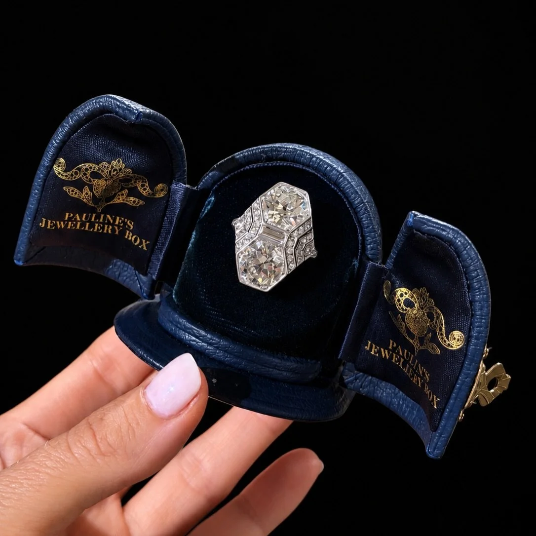 ART DECO TOI ET MOI DIAMOND RING 

Set with two old cut diamonds. Set with 4.25 carats and 4.45 carats. Estimated colour H-I on average. Estimated clarity SI-I on average. Surrounded by 17 baguette cut and brilliant cut diamonds with an estimated tot