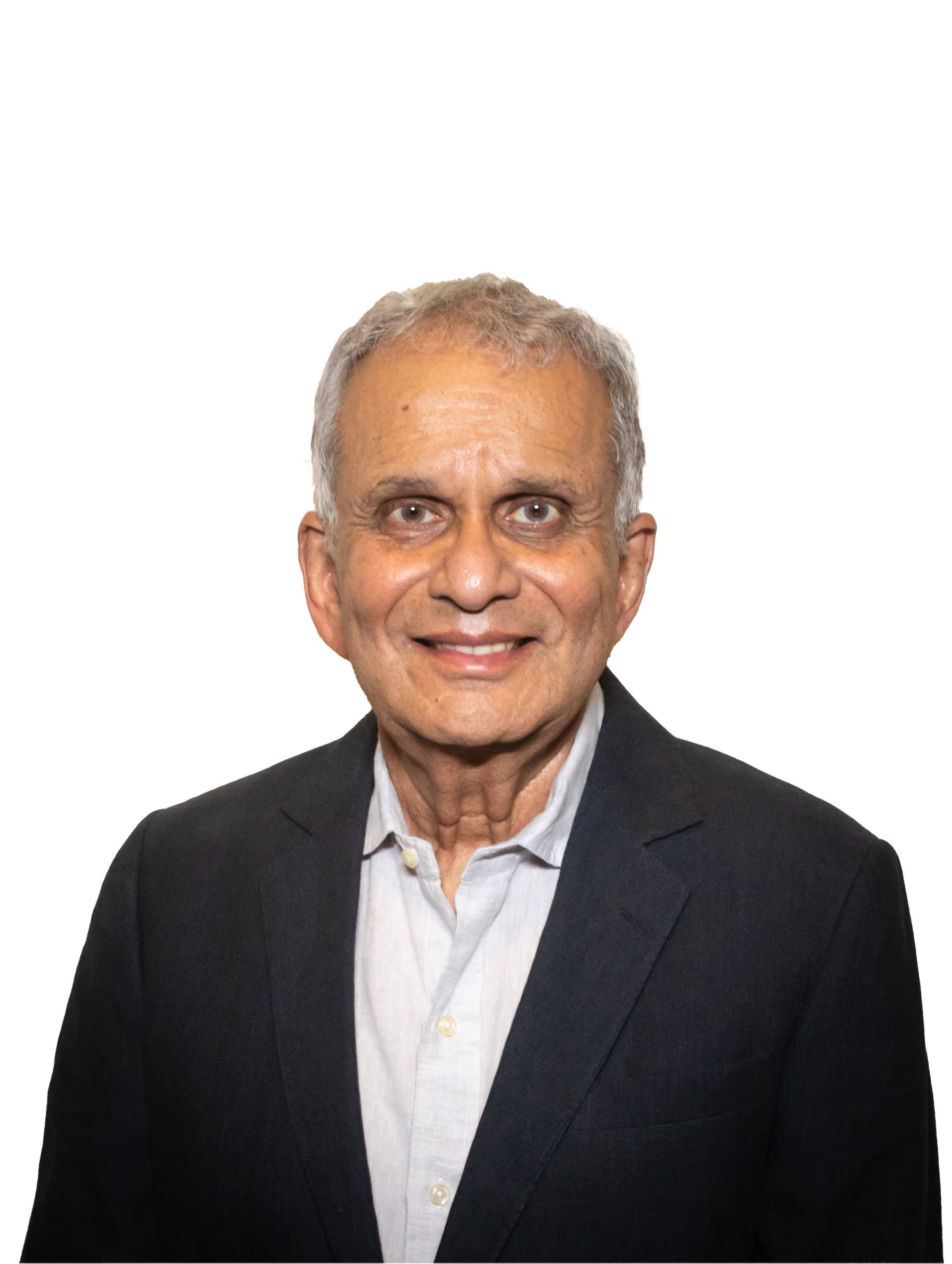 A middle-aged man with gray hair, wearing a black blazer and a white button-up shirt, smiling at the camera against a plain white background.