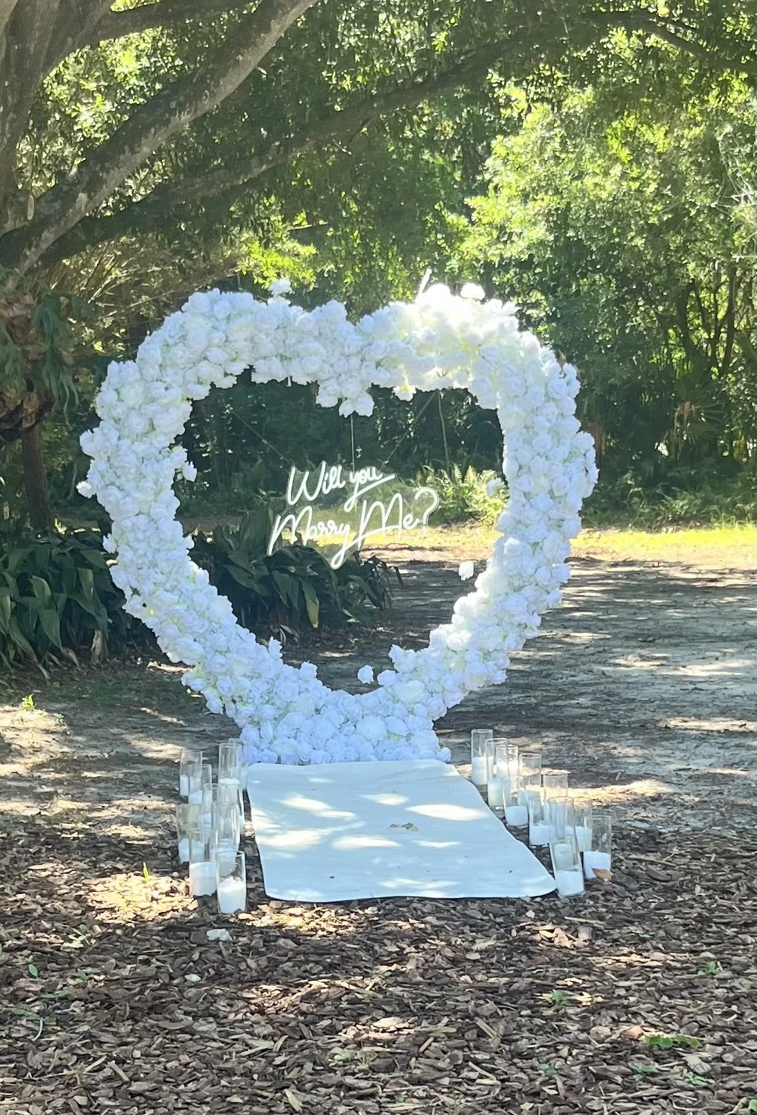 Basic Package
$450
Available in both red or white: Heart Shape Rose Arch, Red Carpet, “Will You Marry Me” LED Sign, Sand Wax Candles, Two Ground Florals, Faux Rose Petals***