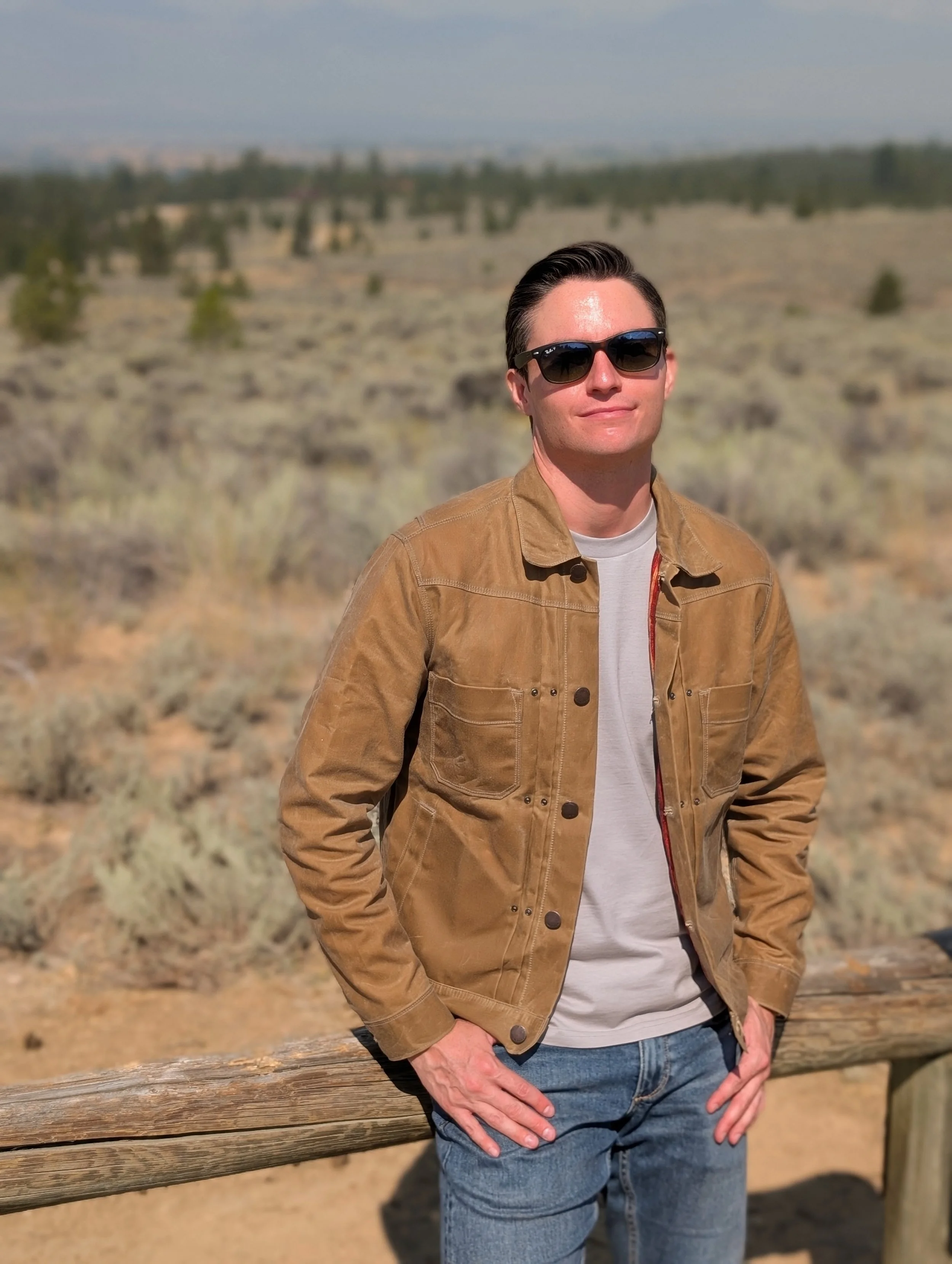 Michael D. Hughes in sunglasses and a suede jacket in the desert