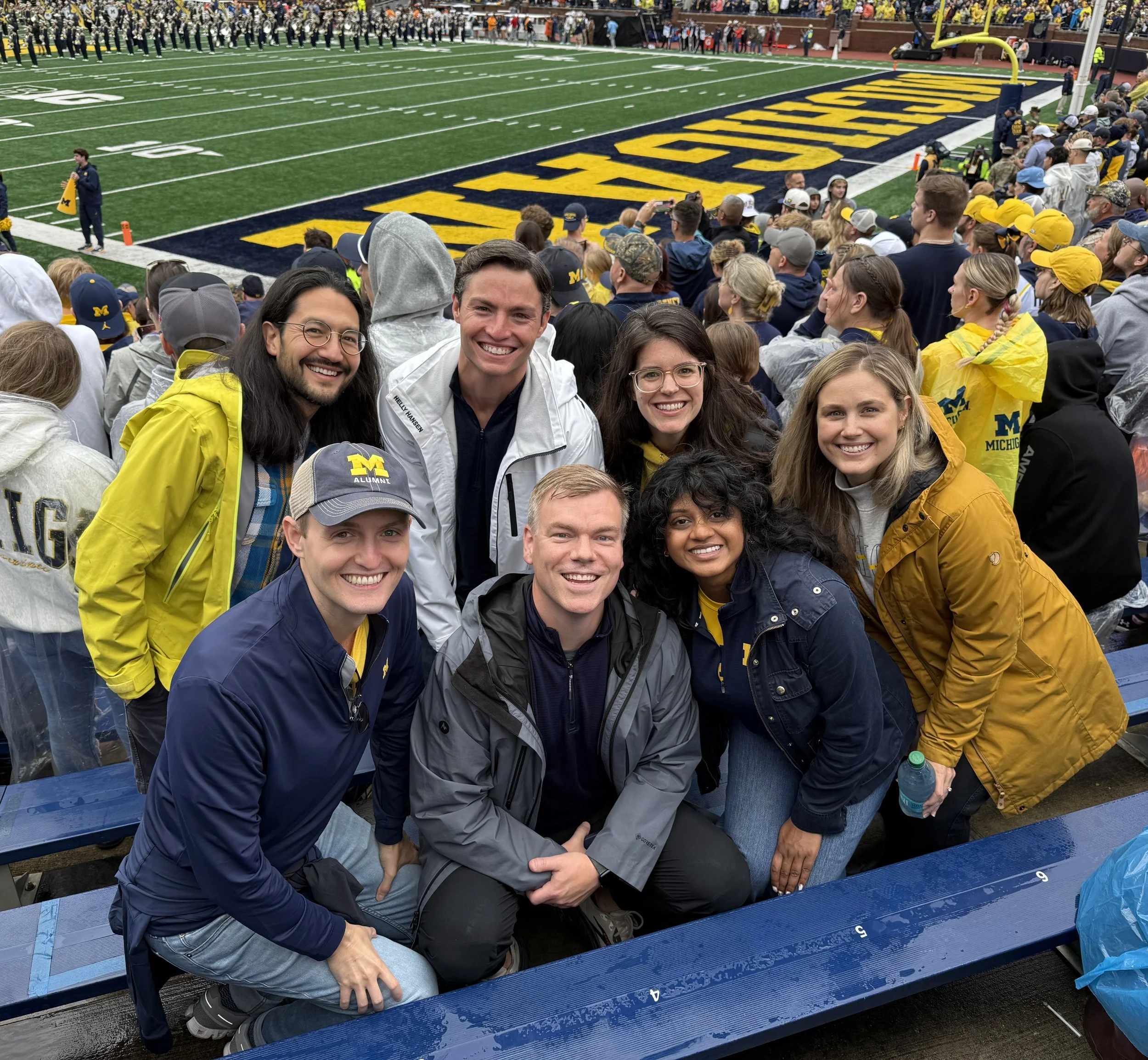 Michael with a group of friends at a college football game