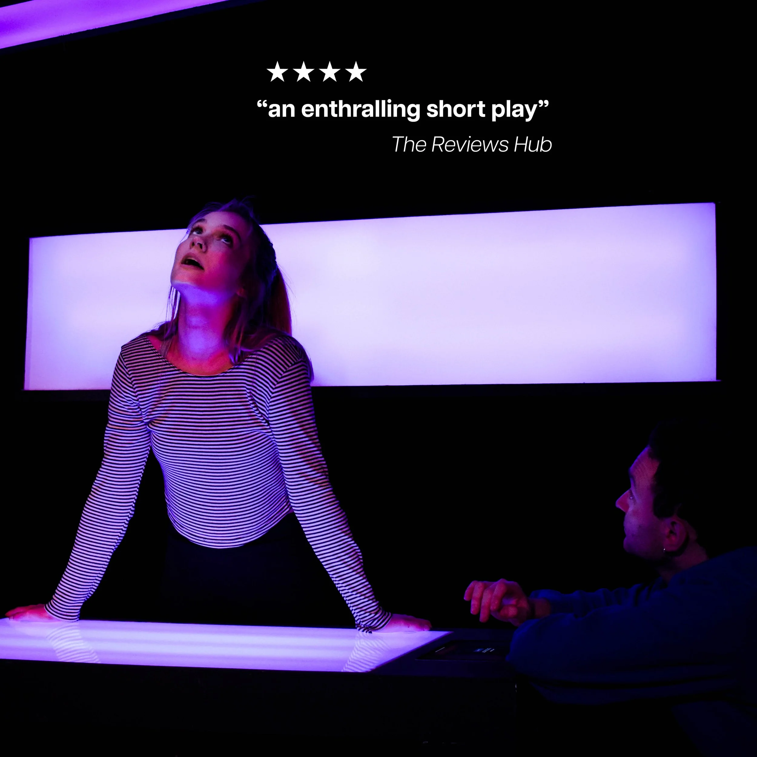 A woman with blonde hair wearing a striped shirt leaning on a lit-up table, looking up with a contemplative expression. A person with short dark hair and beard sits nearby, facing her. Behind them, a dark wall displays a quote and a four-star review.