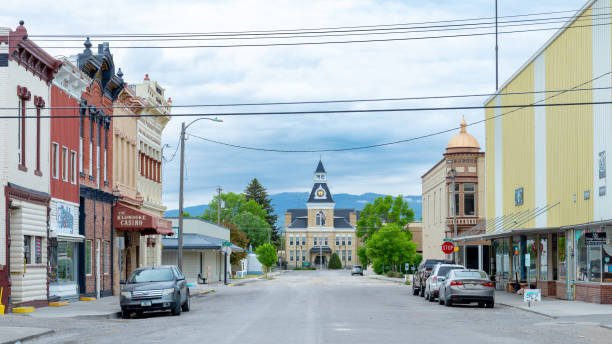 view down a street flanked by historic buildings with a light yellow colored courthouse at the end