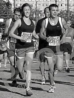 black and white image of a group of runners in shorts and tank tops