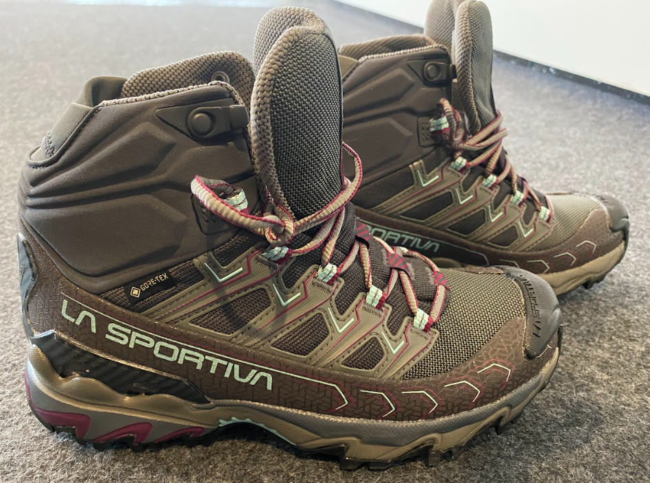 ankle height hiking boots grey in color with fuchsia accents