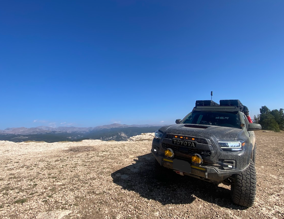 green toyota truck on a white precipice