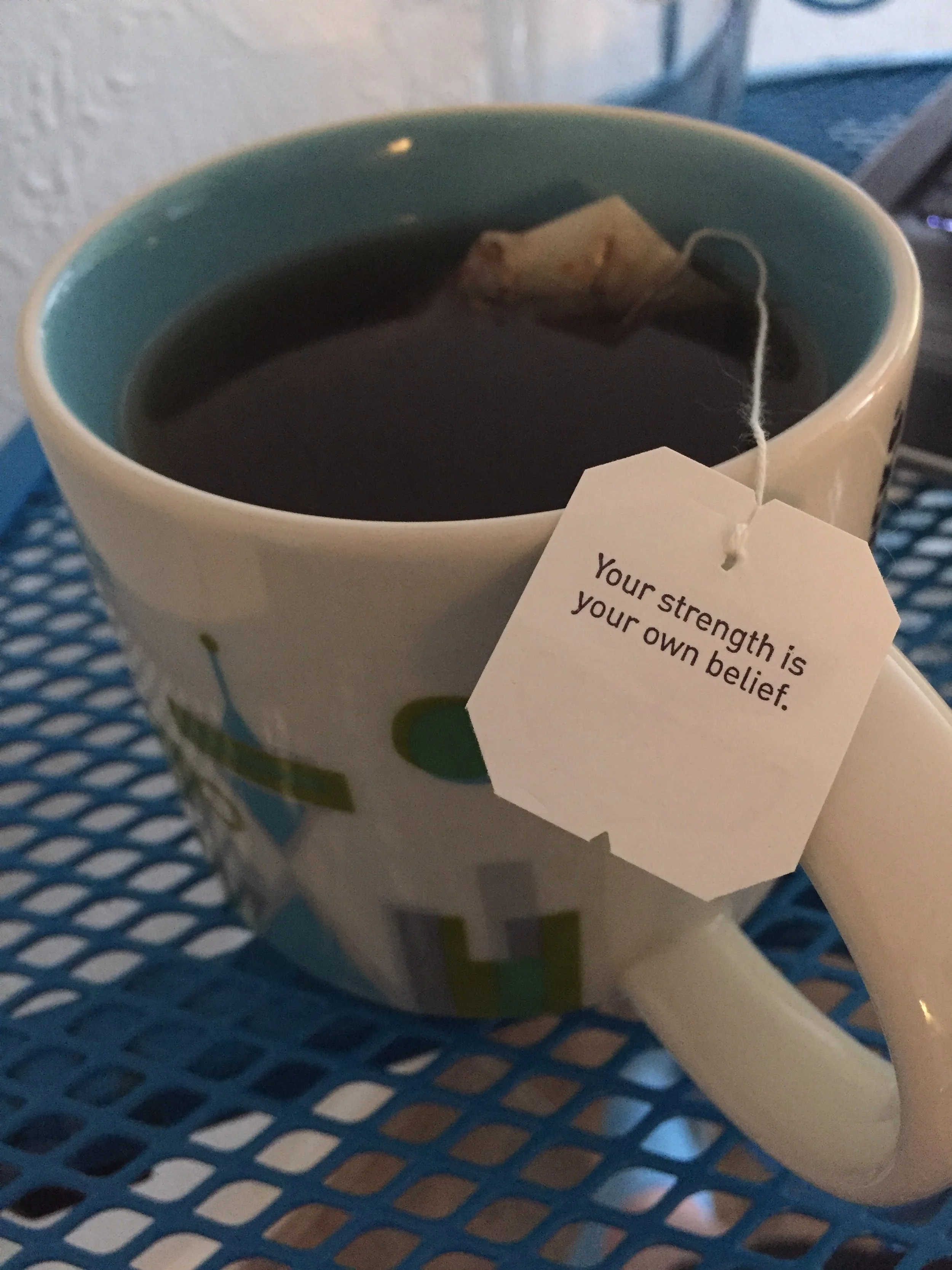 tea and tag has a quote that reads, " Your strength is your own belief."