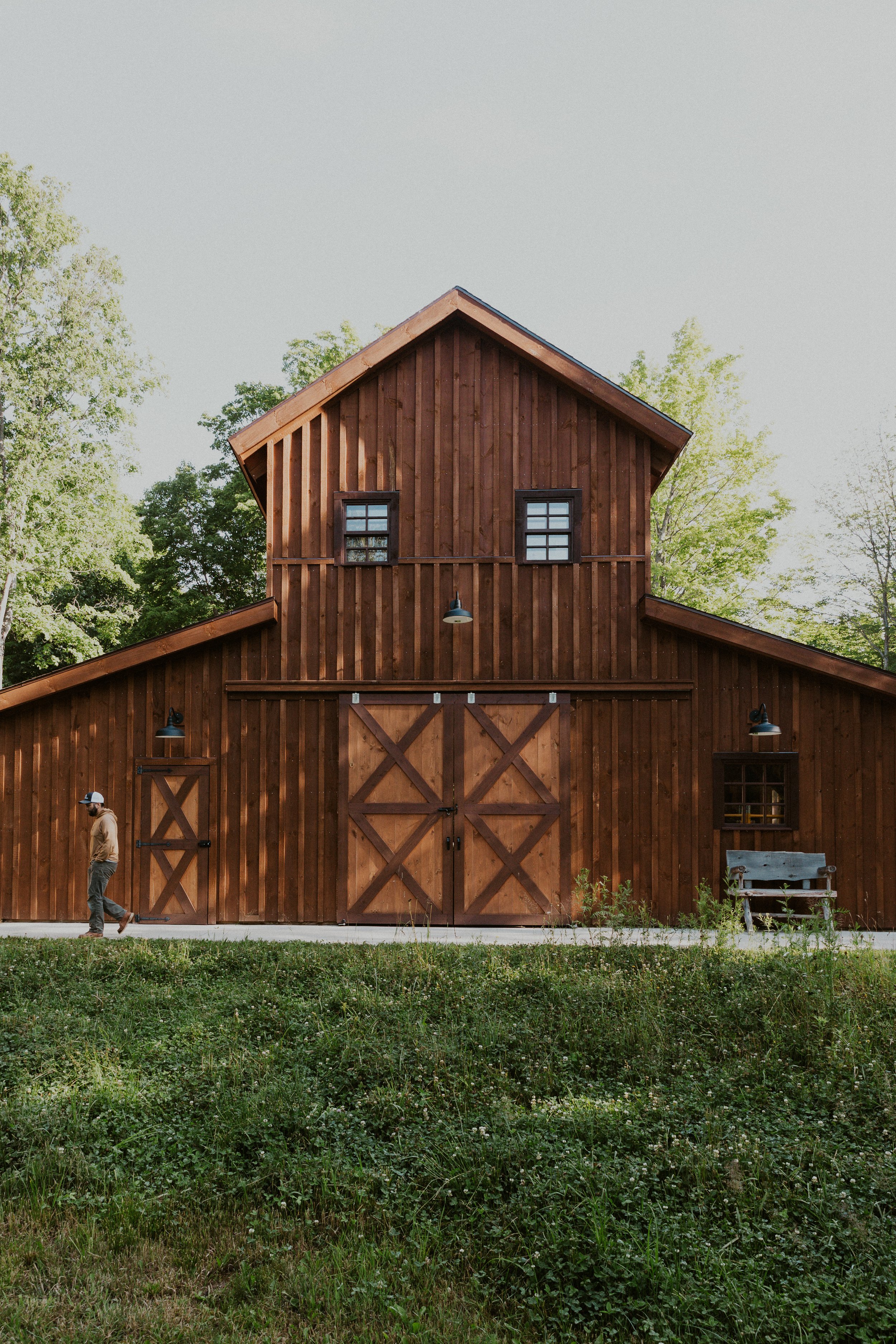 man walking out of barn