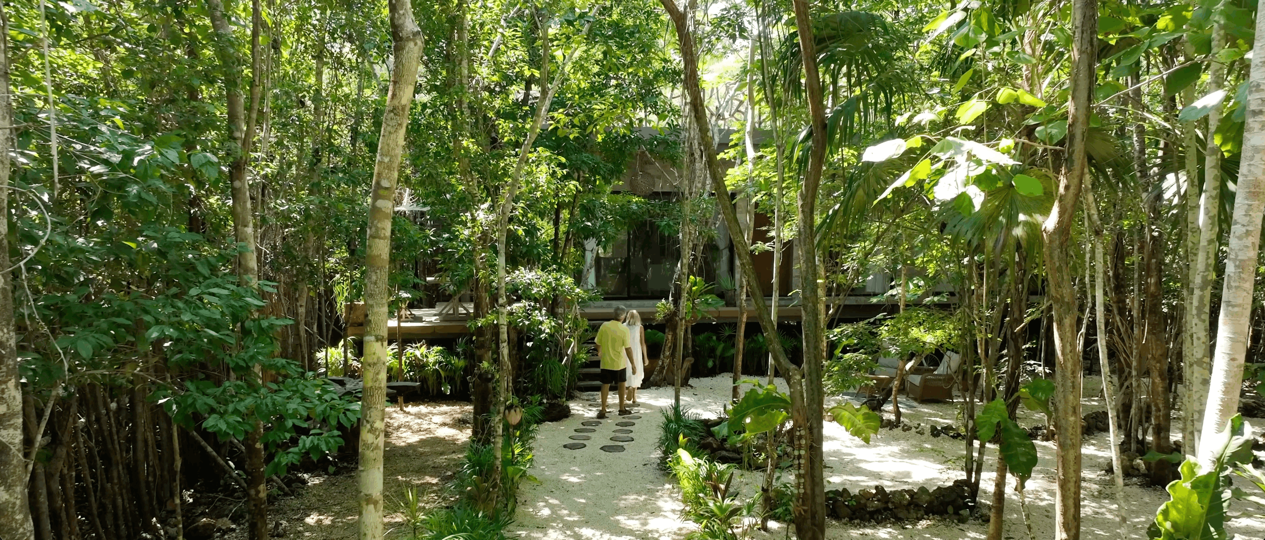 Couple arriving at a secluded jungle residence in Xul-Ha, surrounded by nature