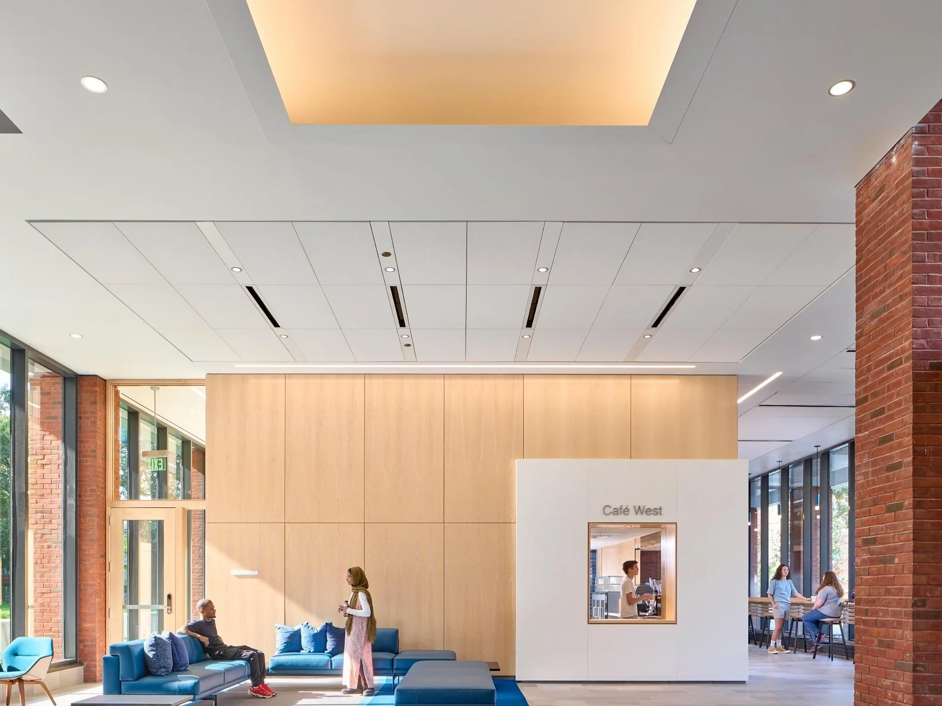 College dormitory entry lobby lighting design with cove lighting and contemporary living space.