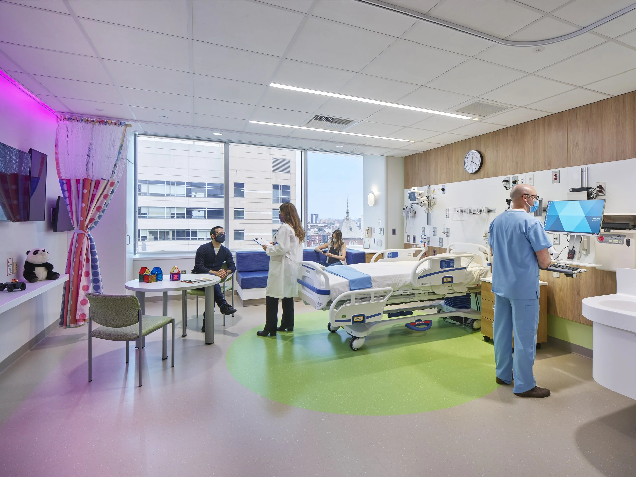 Healthcare patient room lighting design with color-changing cove lighting and tunable white circadian lighting.