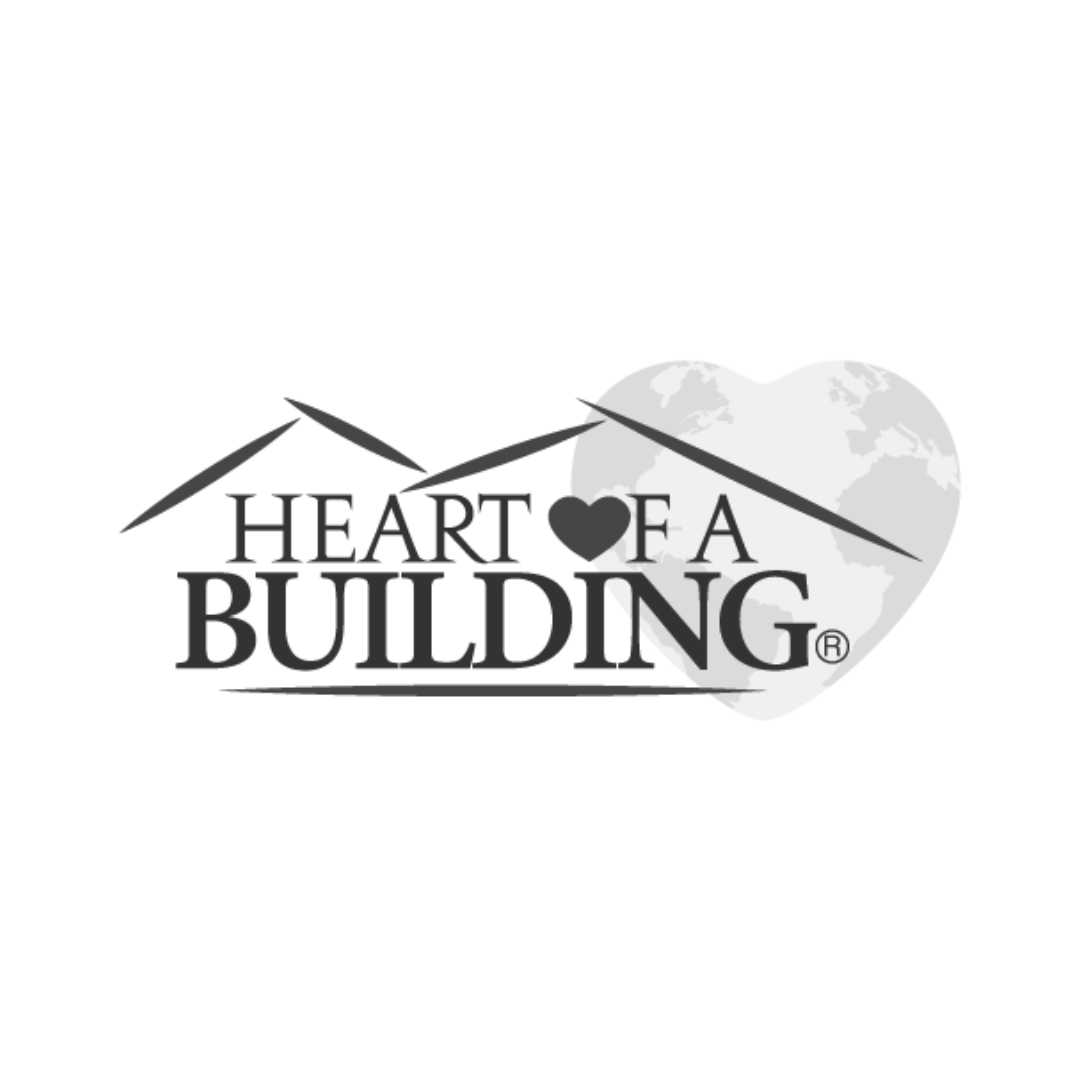 Logo with the words 'Heart of a Building' and a heart symbol, overlaid on a stylized image of a house roof and a globe in the background.