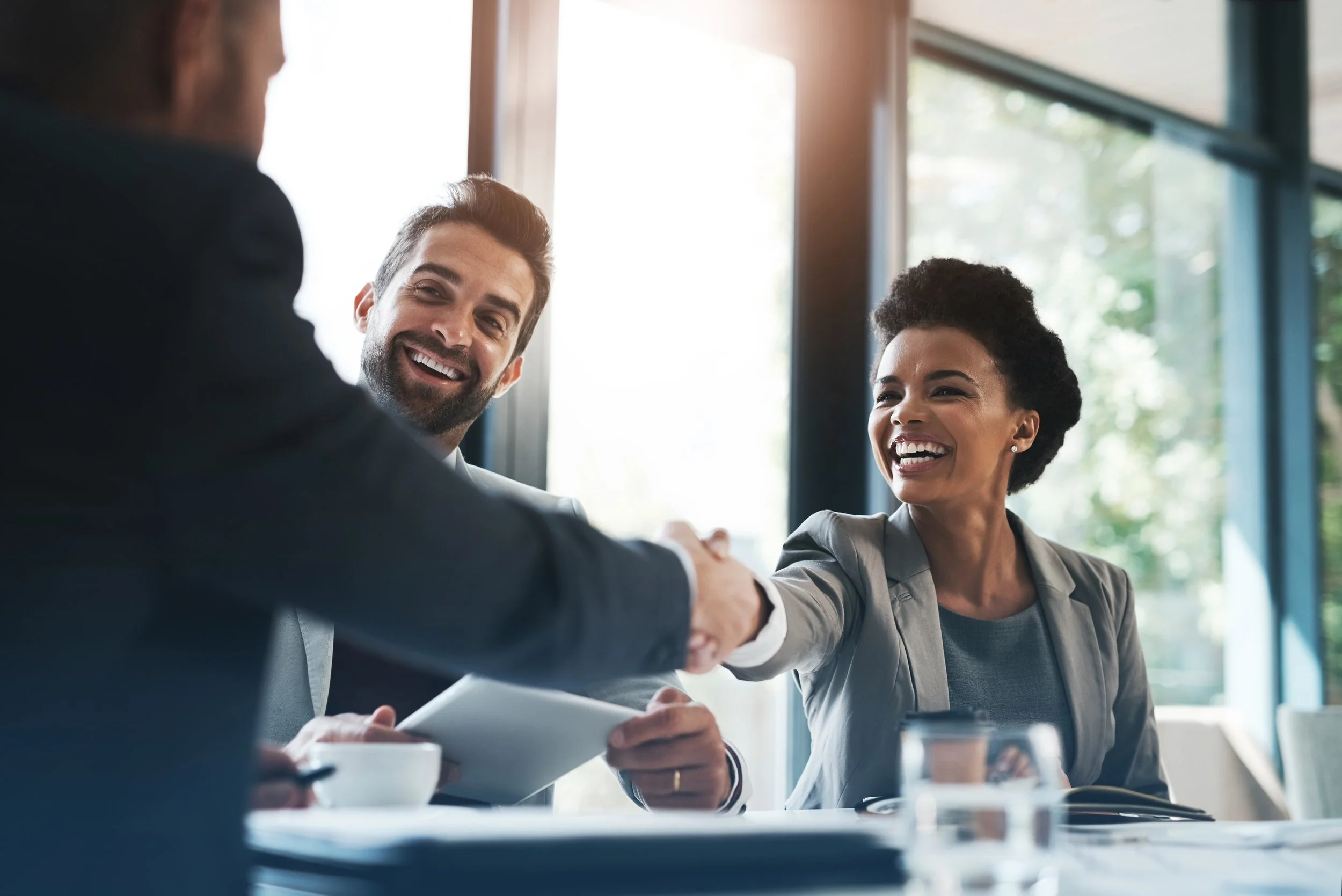 woman-smiling-man-smiling-shaking-hands