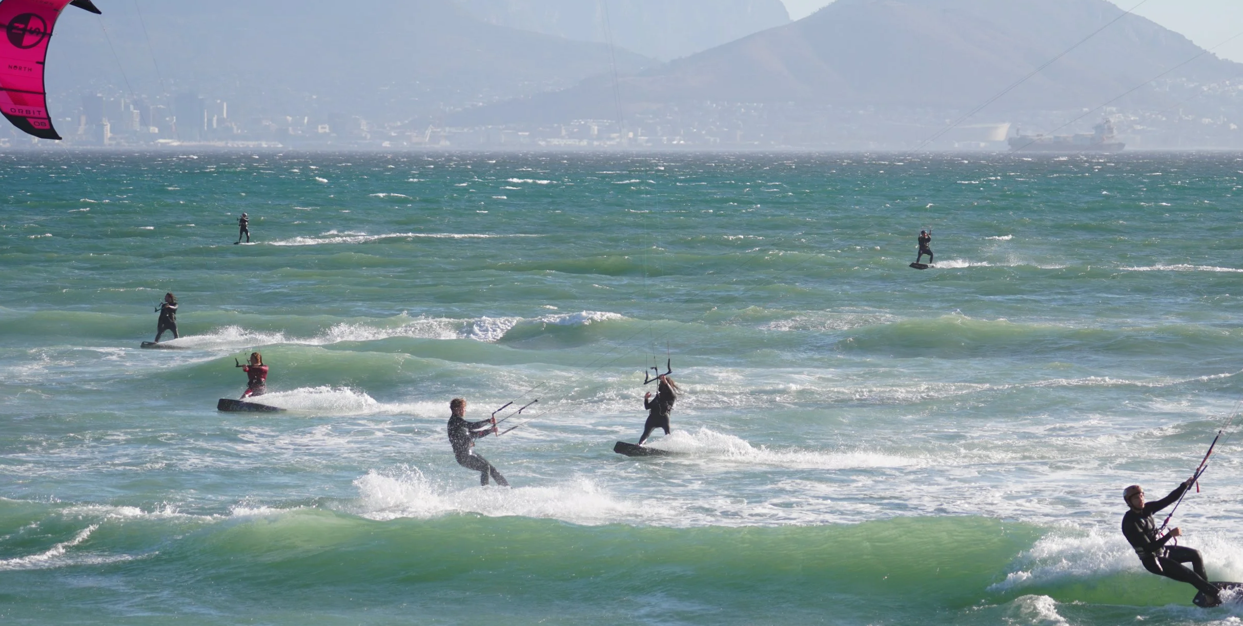 Many kiters on the water