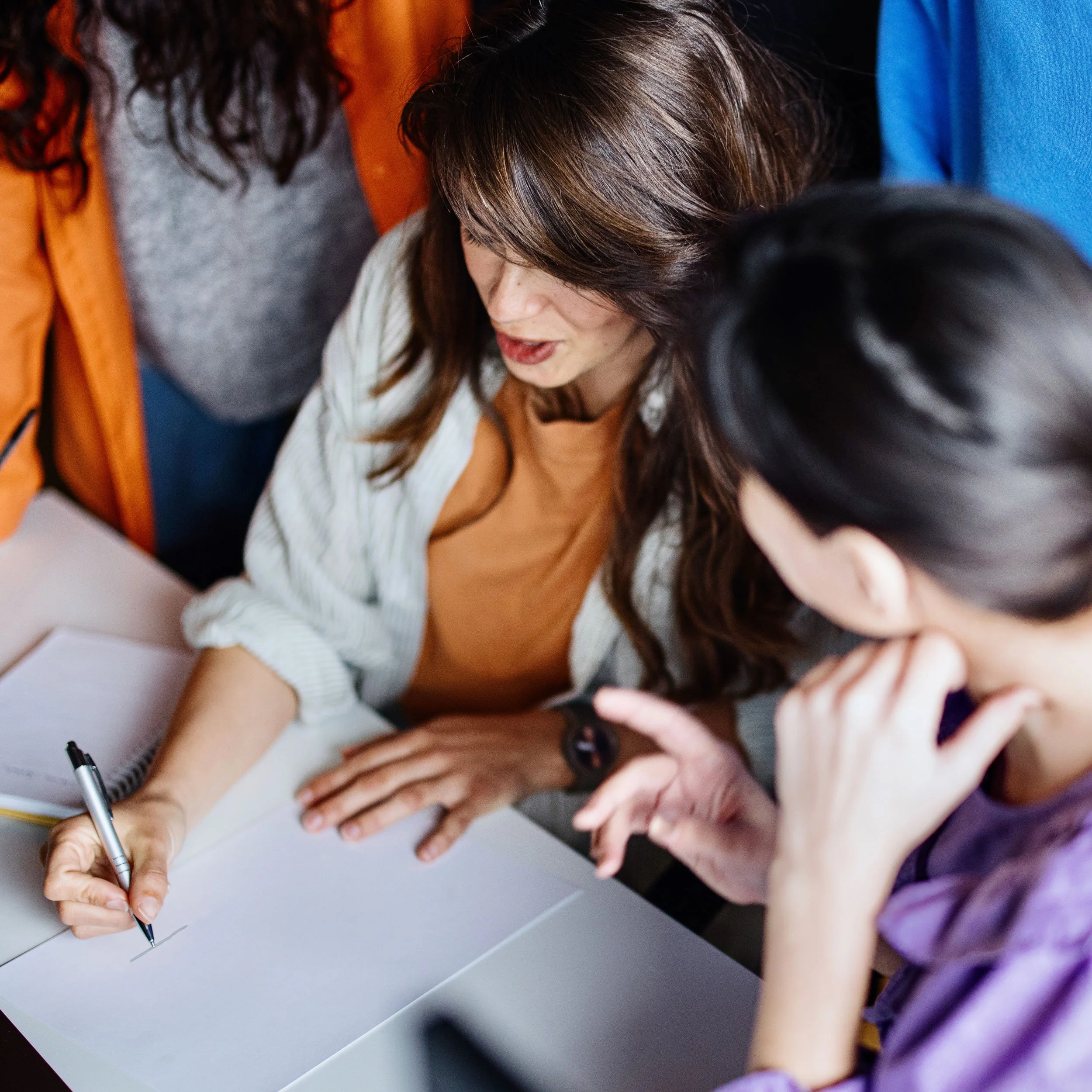 A team collaborating and sharing ideas, representing Flourishing Sparks’ commitment to human-centered consulting, empathy-driven service design, and inclusive community co-design.