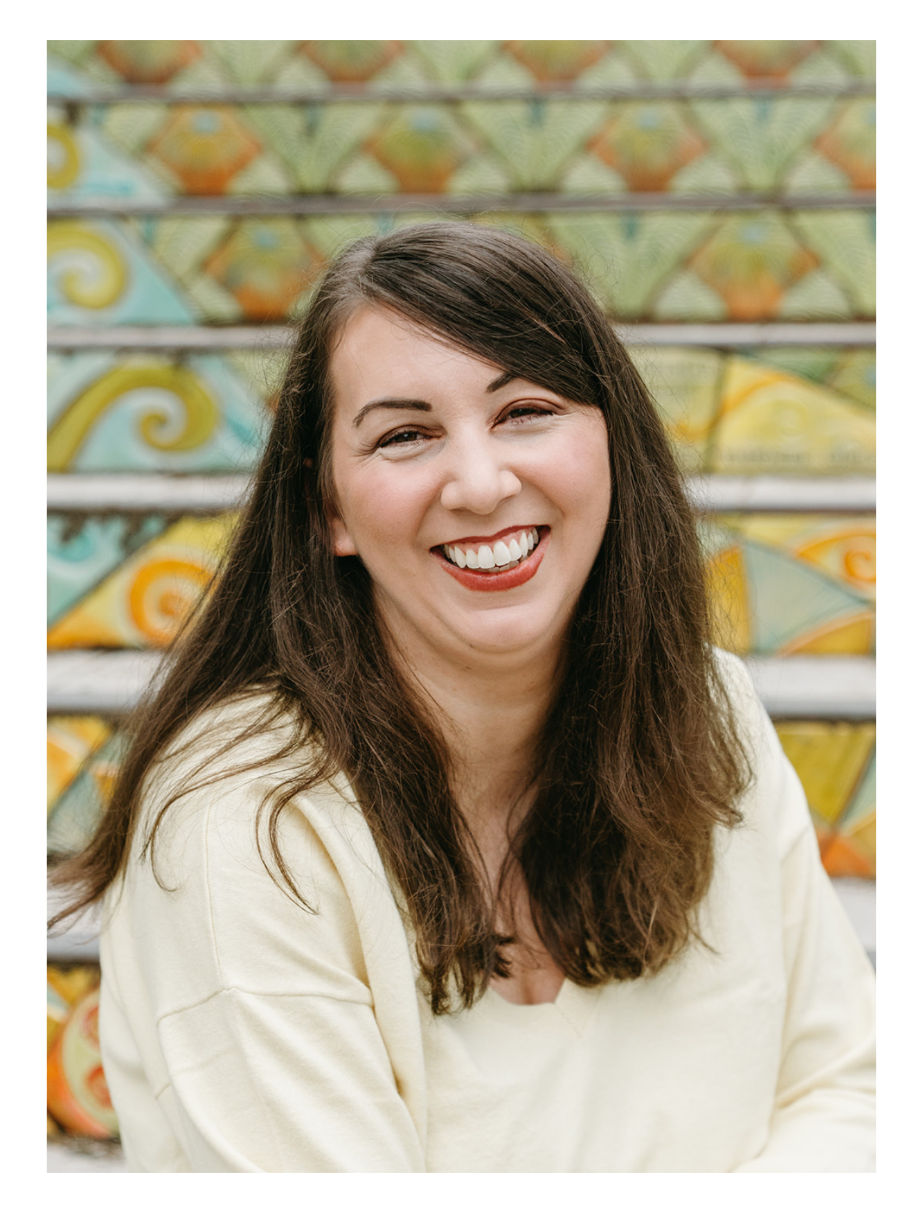Social Media Manager smiling with colorful patterned background. Photo by the amazing photoposy.com